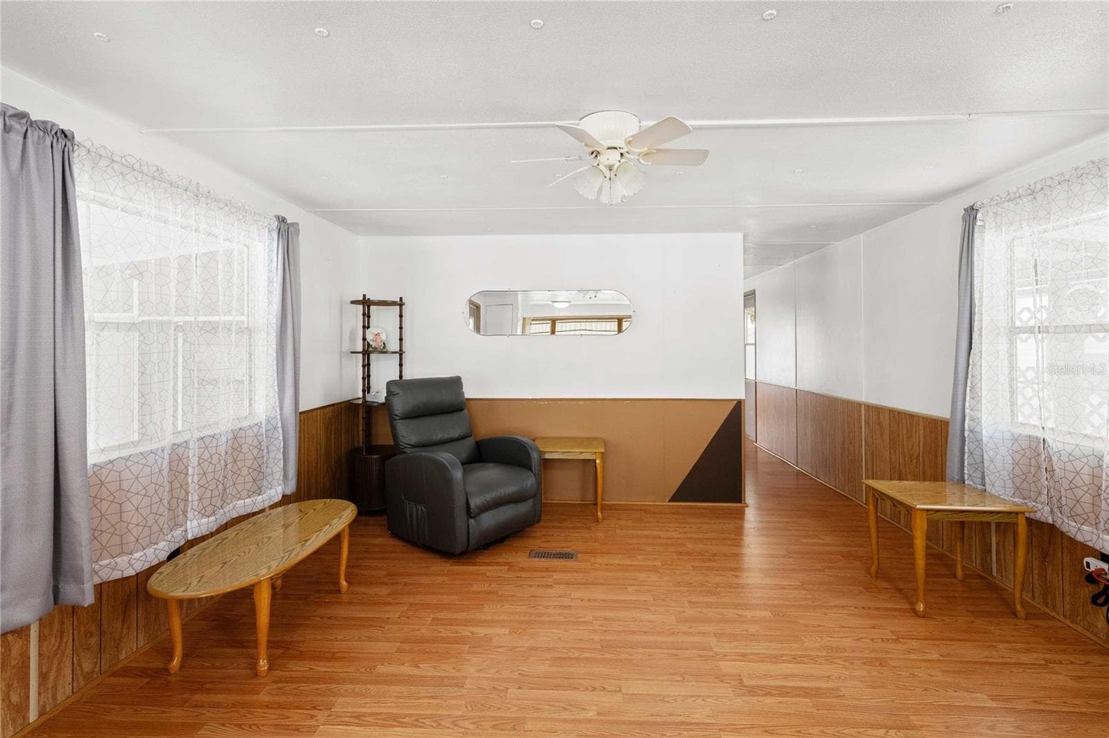Living room has laminate floor. - 5318 ASTRID DR, ZEPHYRHILLS