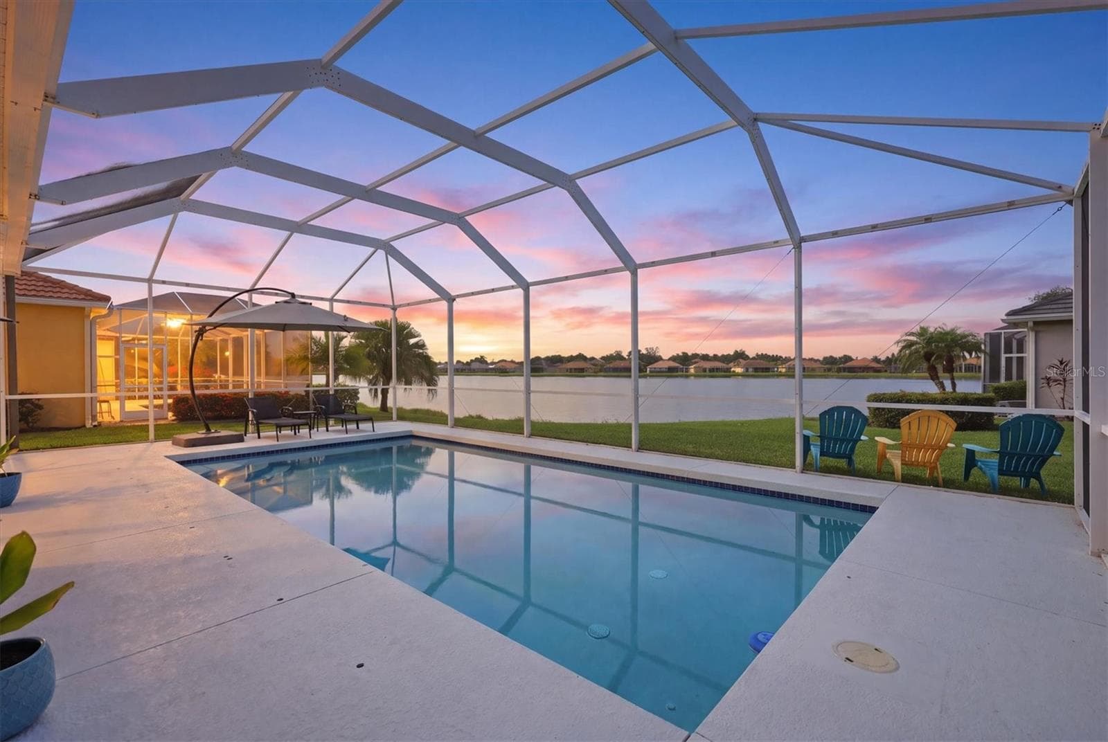 Gas heated pool and lake view - 6904 74TH STREET CIR E, BRADENTON