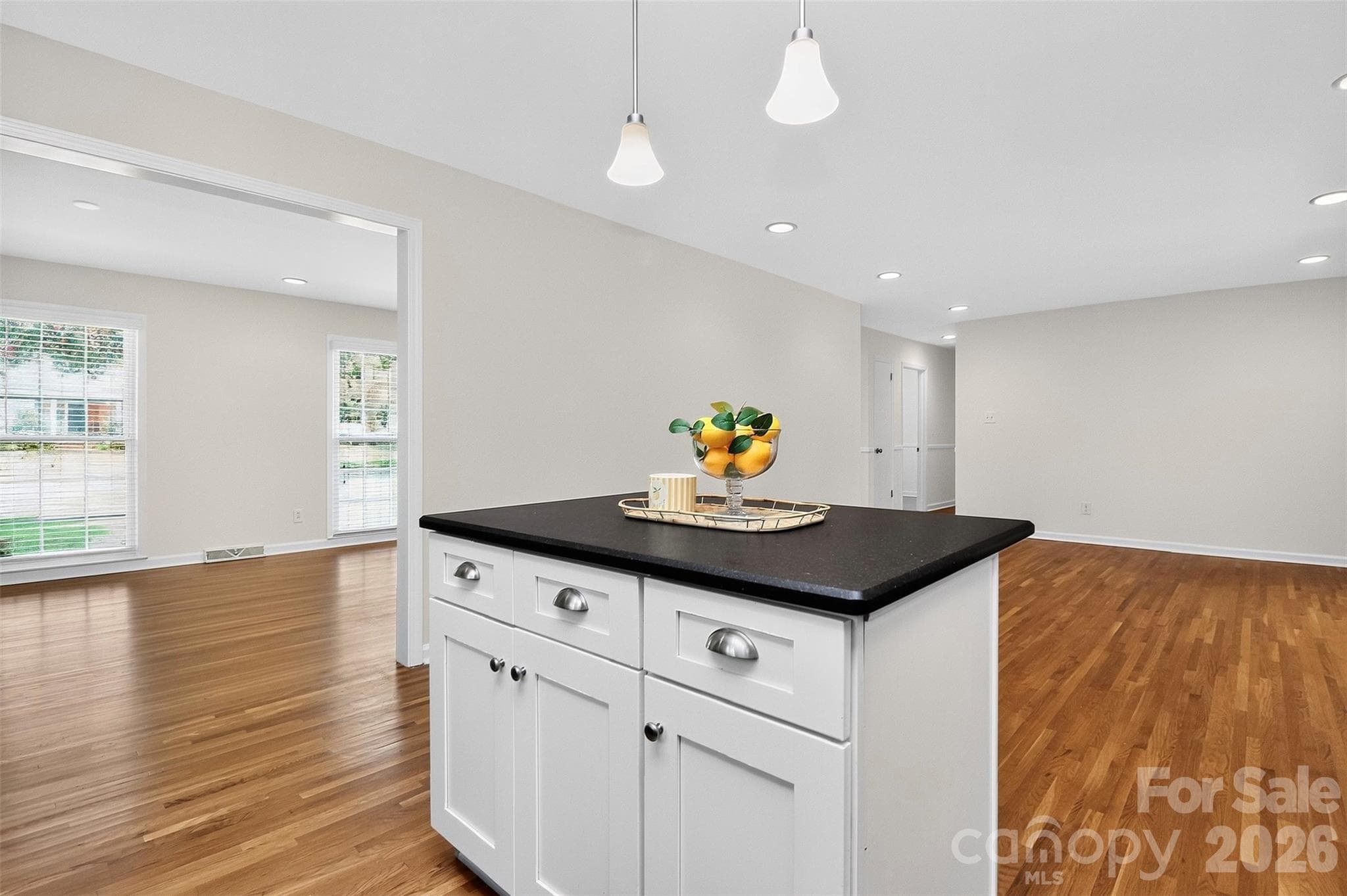 Kitchen island with view into dining room - 4726 Walden Court, Charlotte