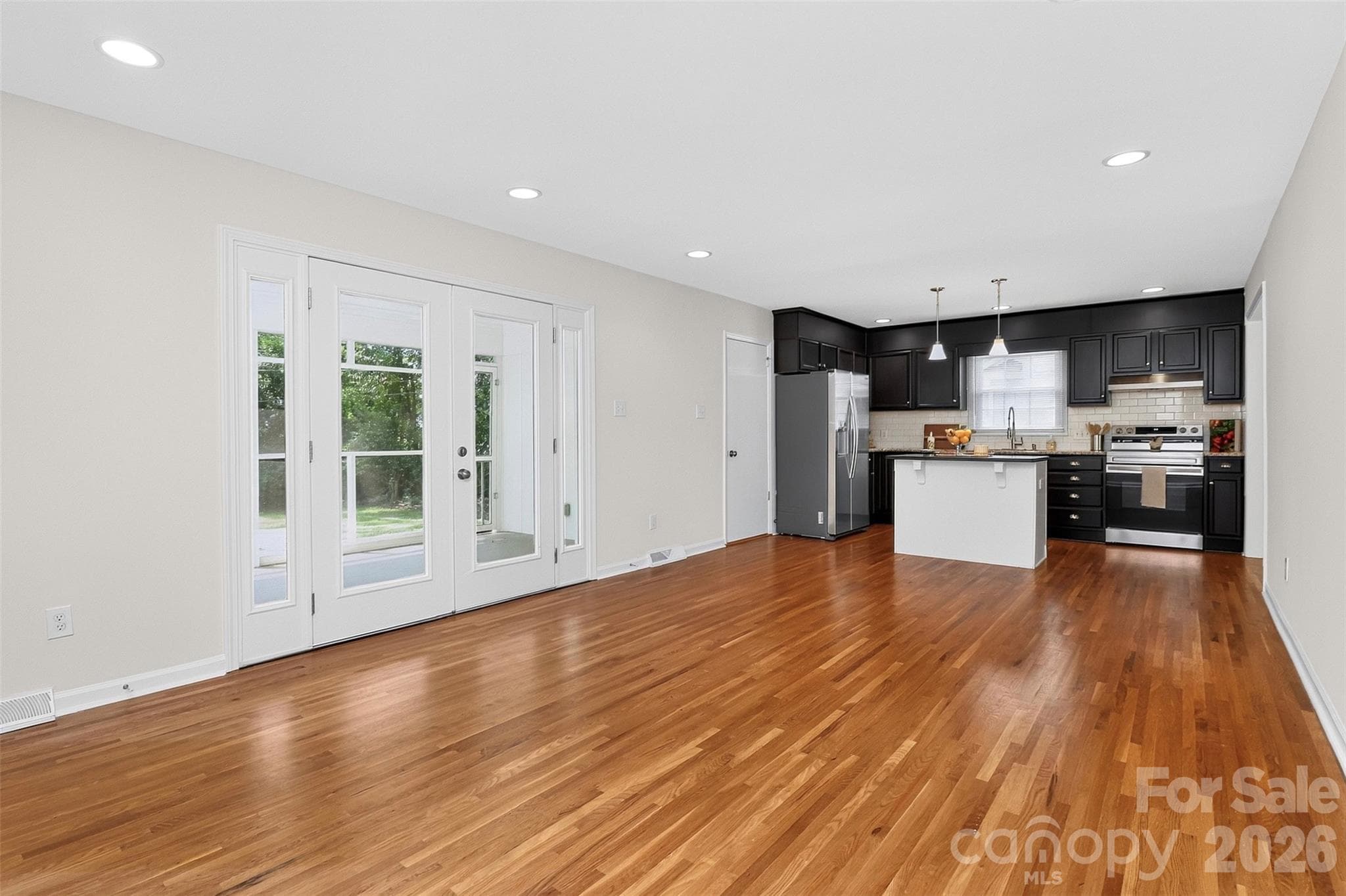 Family room with door to screen porch and kitchen - 4726 Walden Court, Charlotte