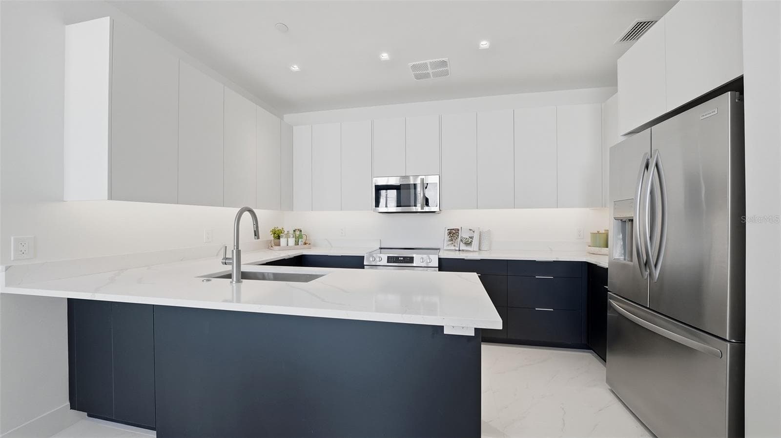 This designer kitchen is ready for your special chef's cuisine with its European cabinetry, stainless appliances and luxurious quartz countertops. - 430 KUMQUAT CT #202, SARASOTA