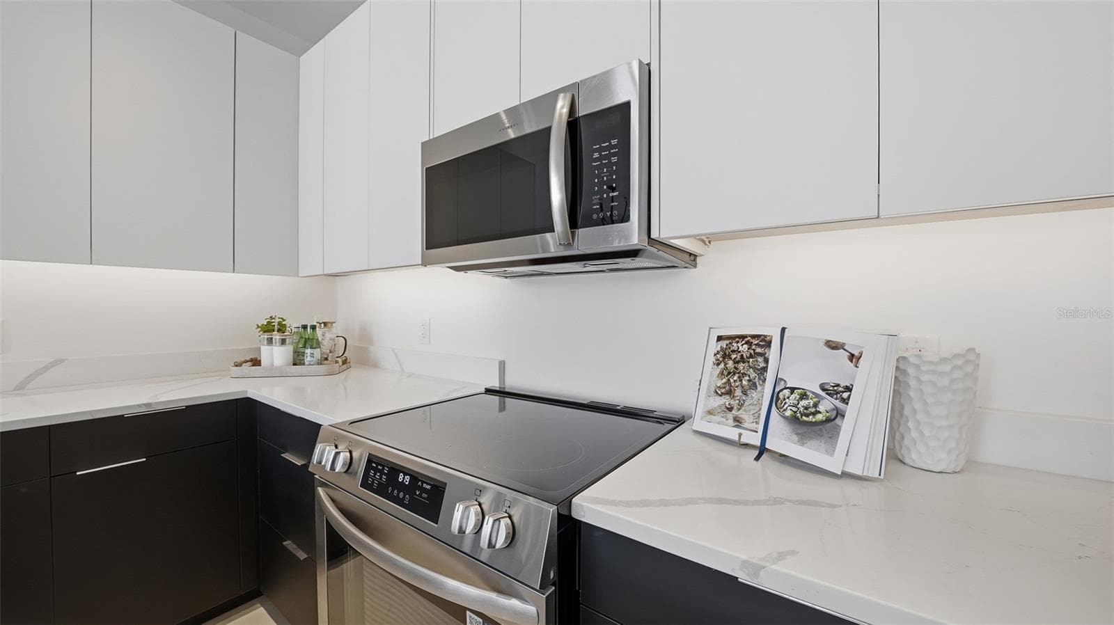 This designer kitchen is ready for your special chef's cuisine with its European cabinetry, stainless appliances and luxurious quartz countertops. - 430 KUMQUAT CT #202, SARASOTA