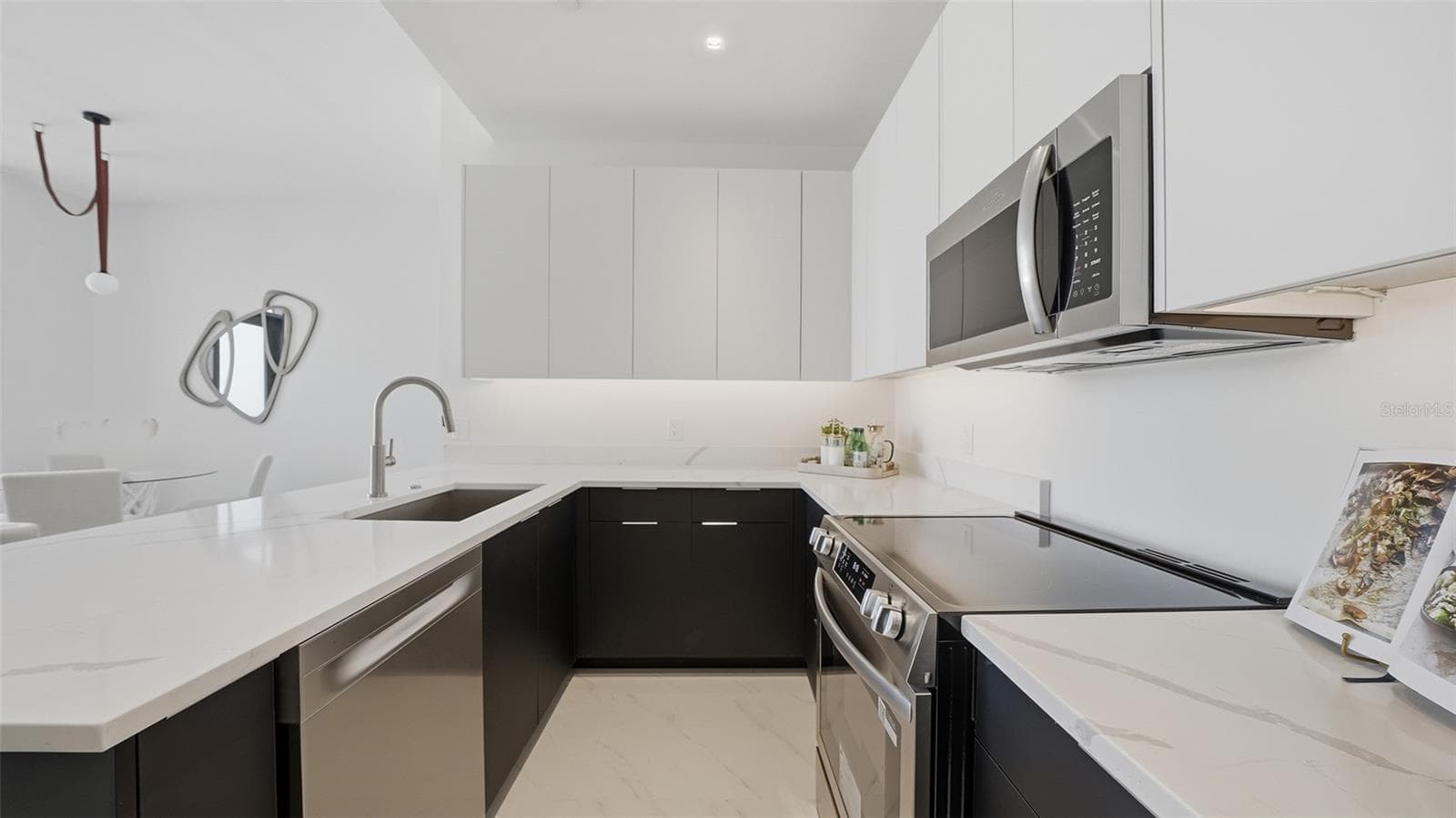 This designer kitchen is ready for your special chef's cuisine with its European cabinetry, stainless appliances and luxurious quartz countertops. - 430 KUMQUAT CT #202, SARASOTA