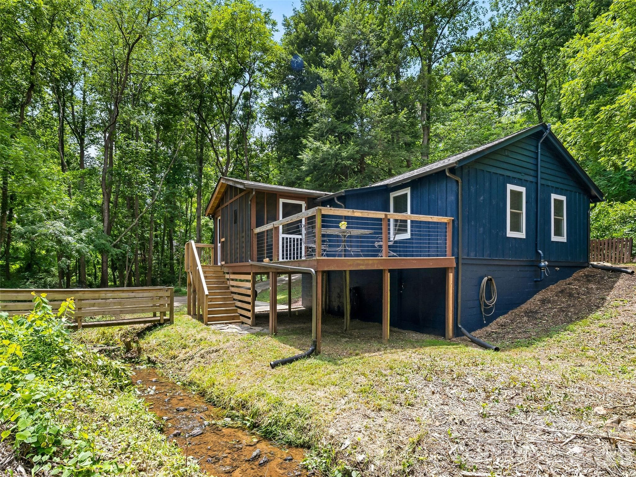 View of home from across the creek. - 468 Governors View Road, Asheville