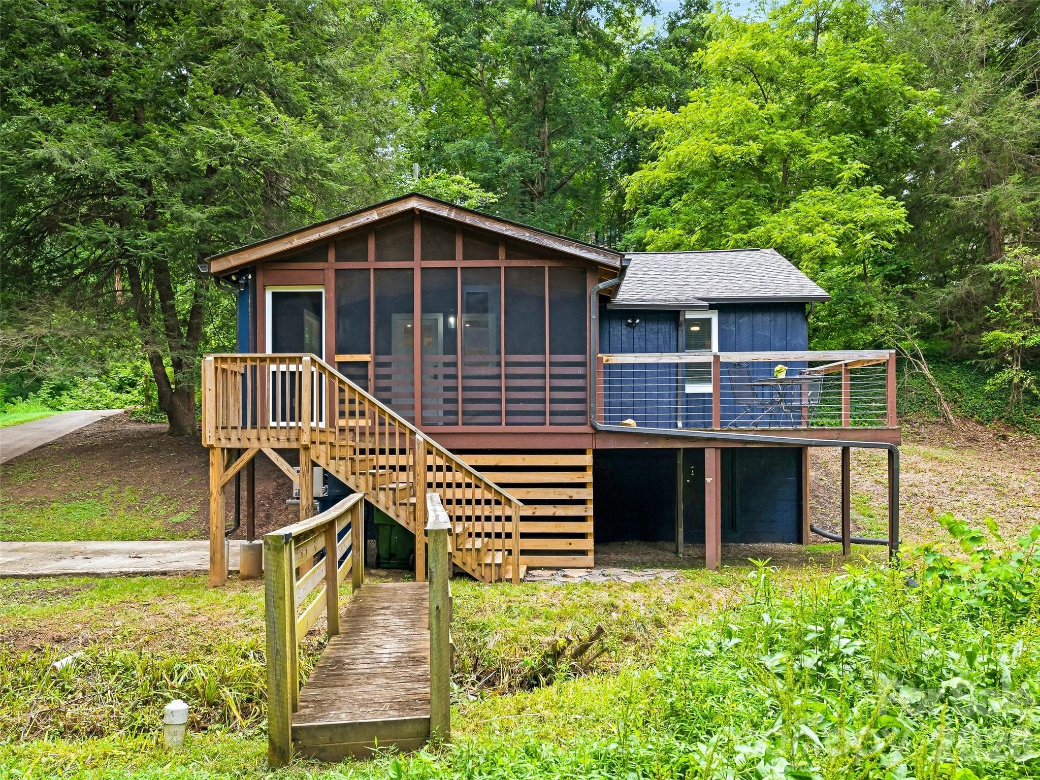 View of home from backyard across the creek. - 468 Governors View Road, Asheville