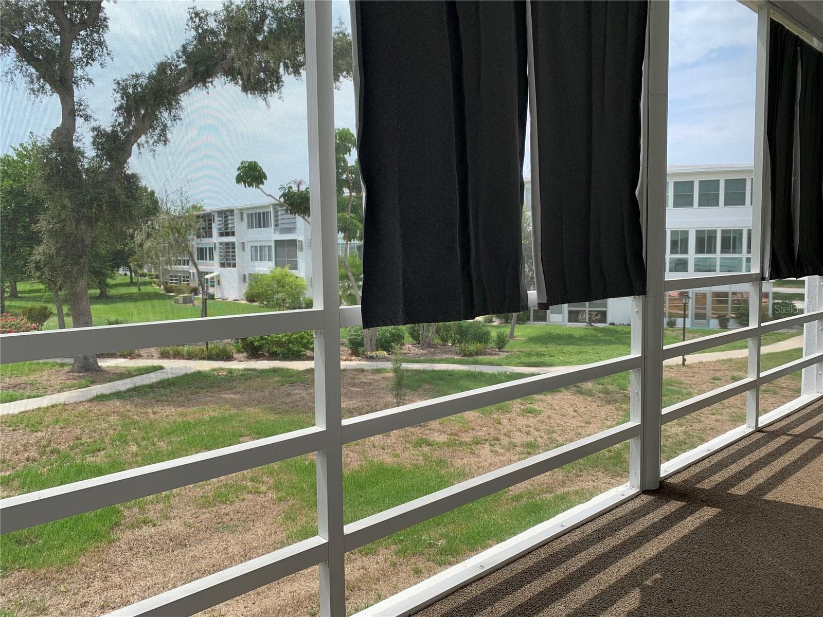 Back porch looks out over a gorgeous garden area - 8126 112TH ST #203, SEMINOLE