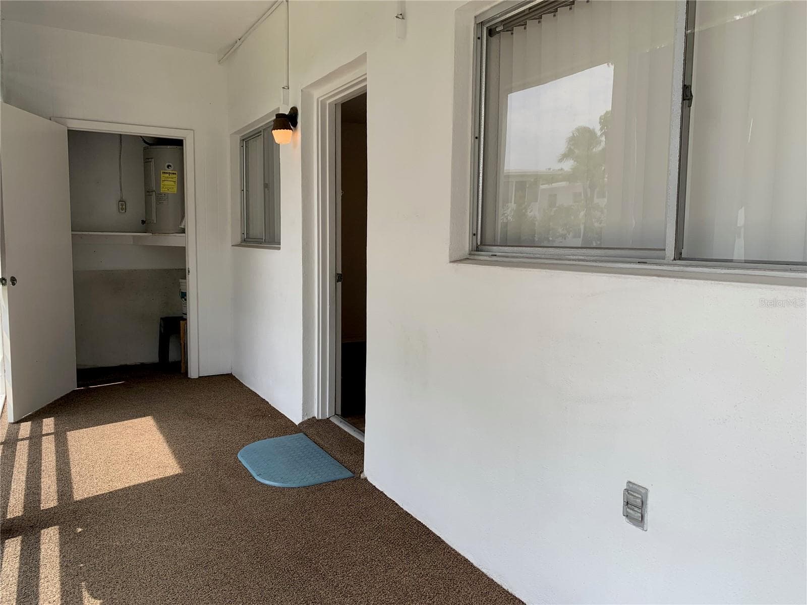 View of storage closet on back porch; door to right goes back into bedroom 2 inside - 8126 112TH ST #203, SEMINOLE