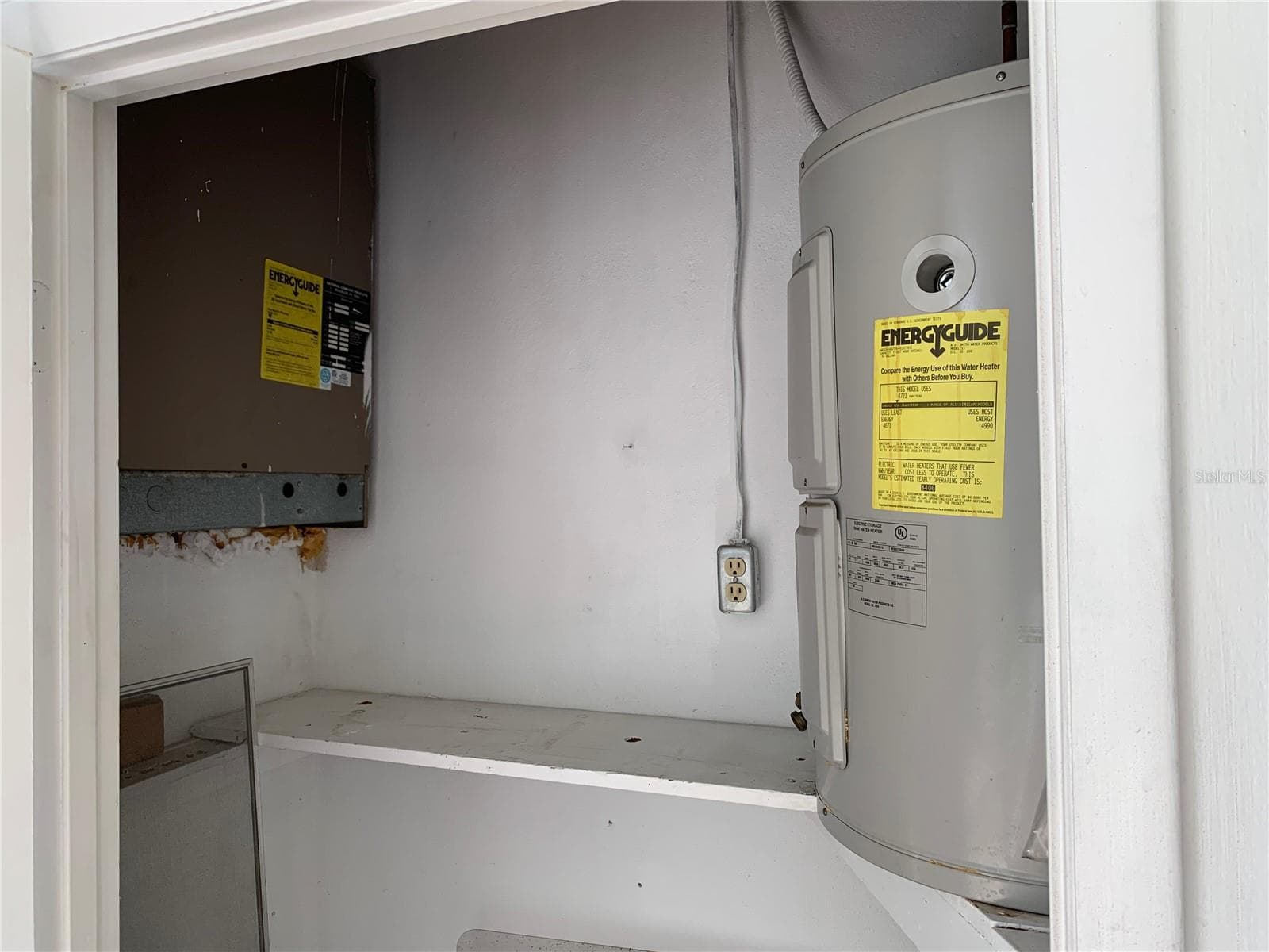 AC and water heater in back porch storage closet - 8126 112TH ST #203, SEMINOLE
