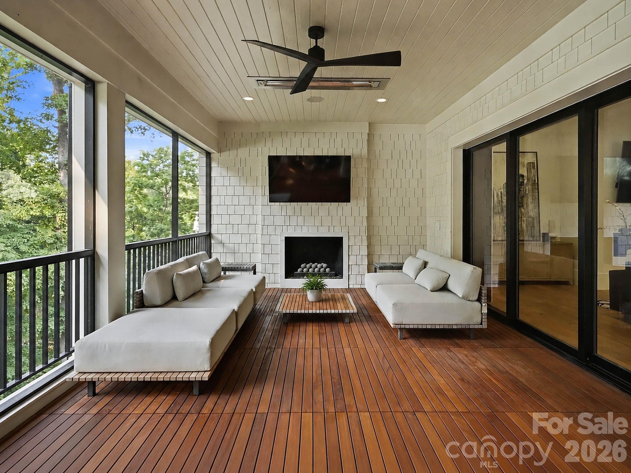 Cozy up on a cool night on the screened in porch- featuring heat lamps and a fireplace. - 13702 Sage Thrasher Lane, Charlotte