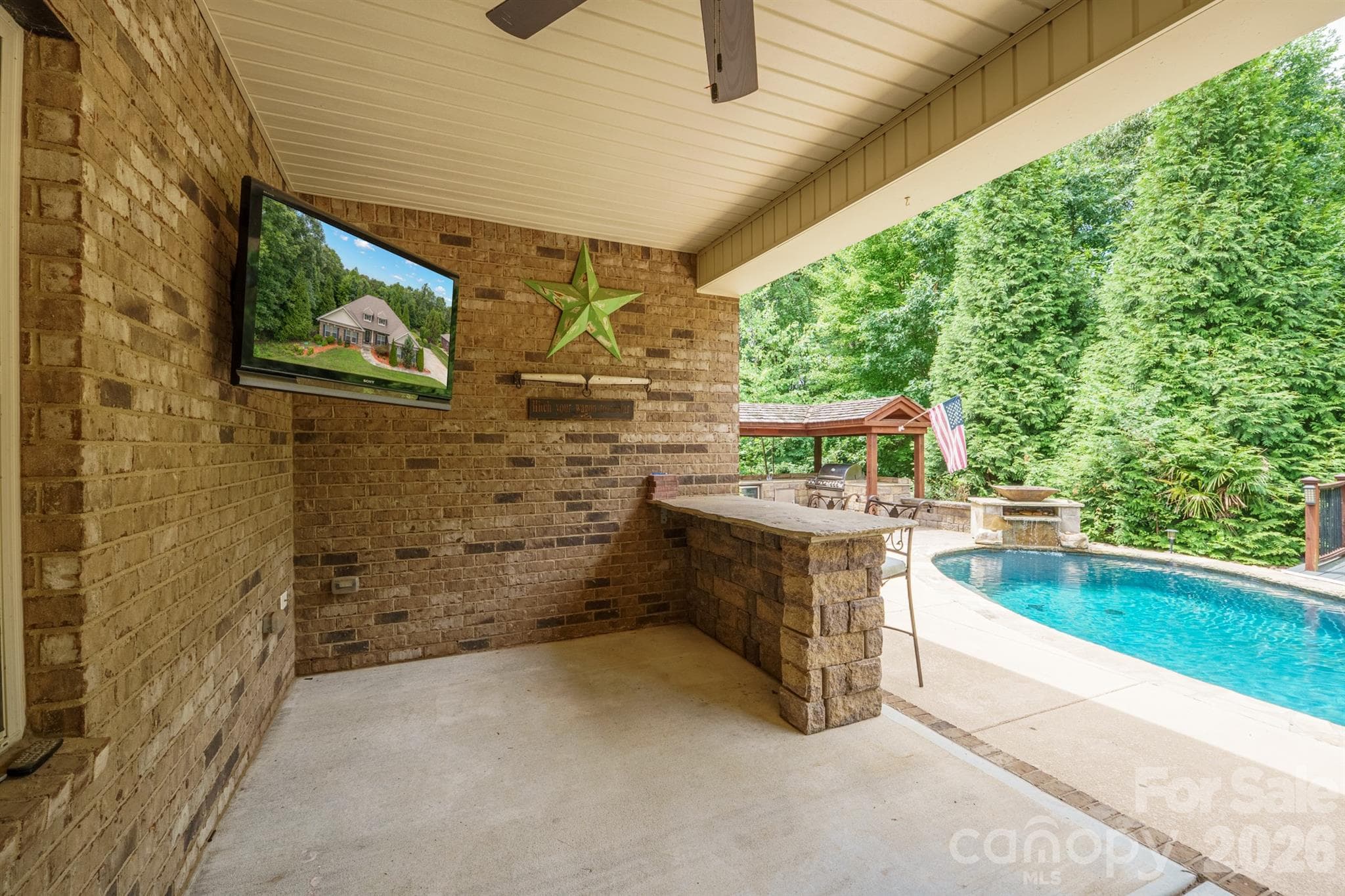 covered back patio leading to pool deck - 589 Shepherd Road, Troutman