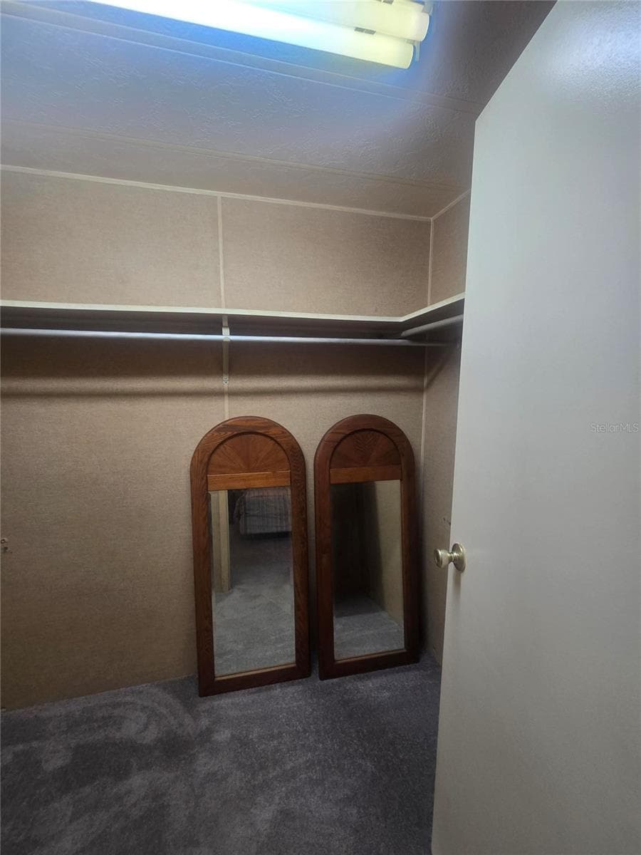 Primary walk-in closet - 4645 BURNEY DR, HOLIDAY