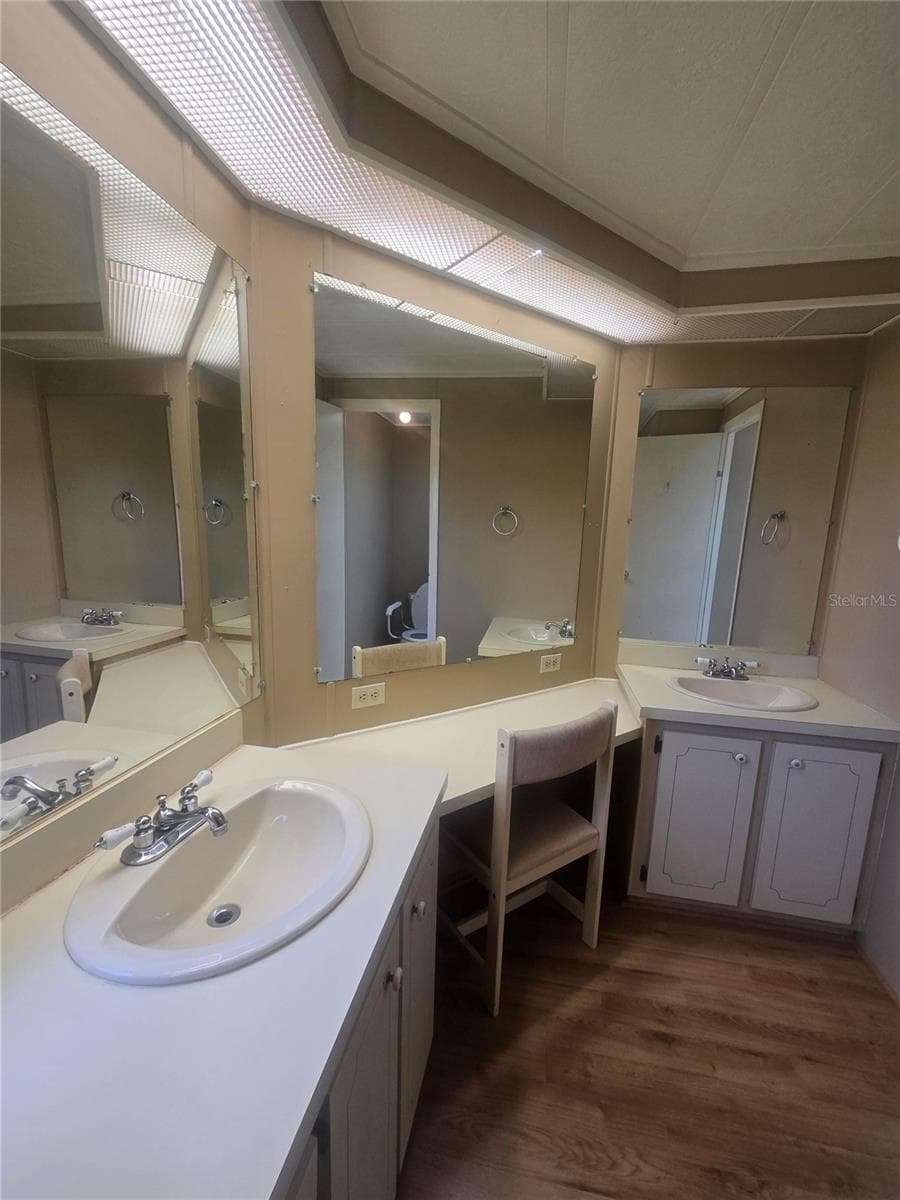 En suite with dual sinks and makeup vanity - 4645 BURNEY DR, HOLIDAY