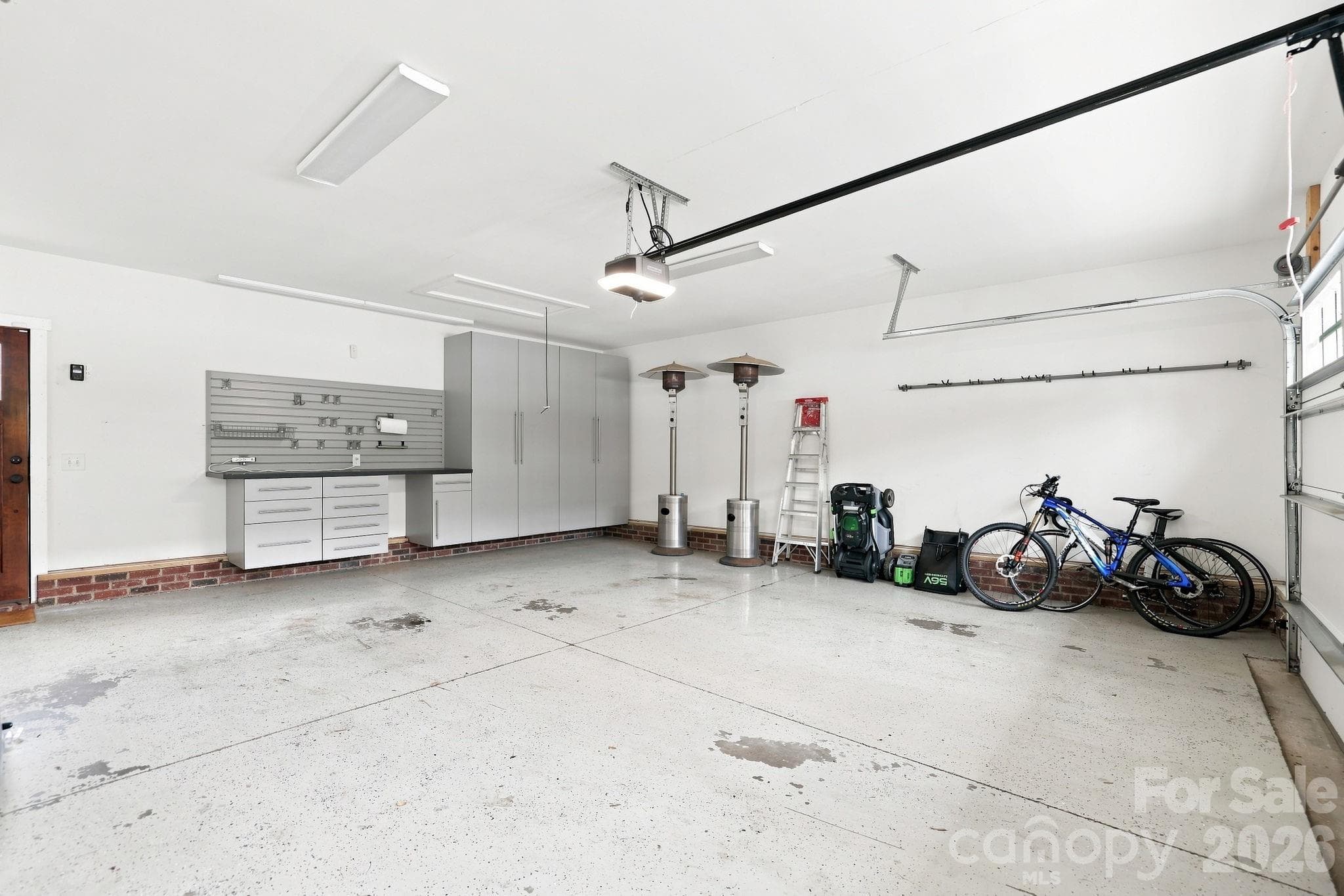 Large garage with cabinetry. - 2617 Commonwealth Avenue, Charlotte