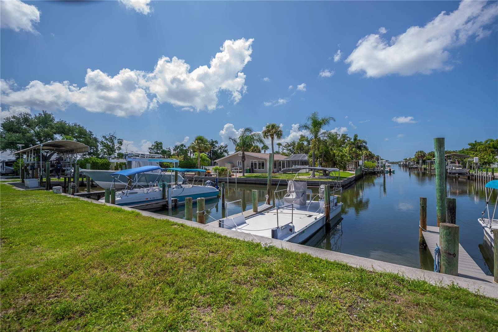 Deeded dock (dock with the blue Bimini top boat - boat not included). - 8152 SEASHELL ST, ENGLEWOOD