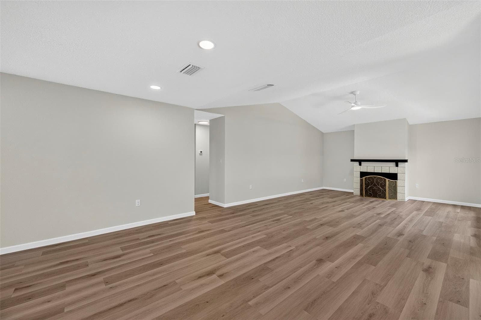 Living room with a fireplace - 647 BONNIE BLVD, PALM HARBOR