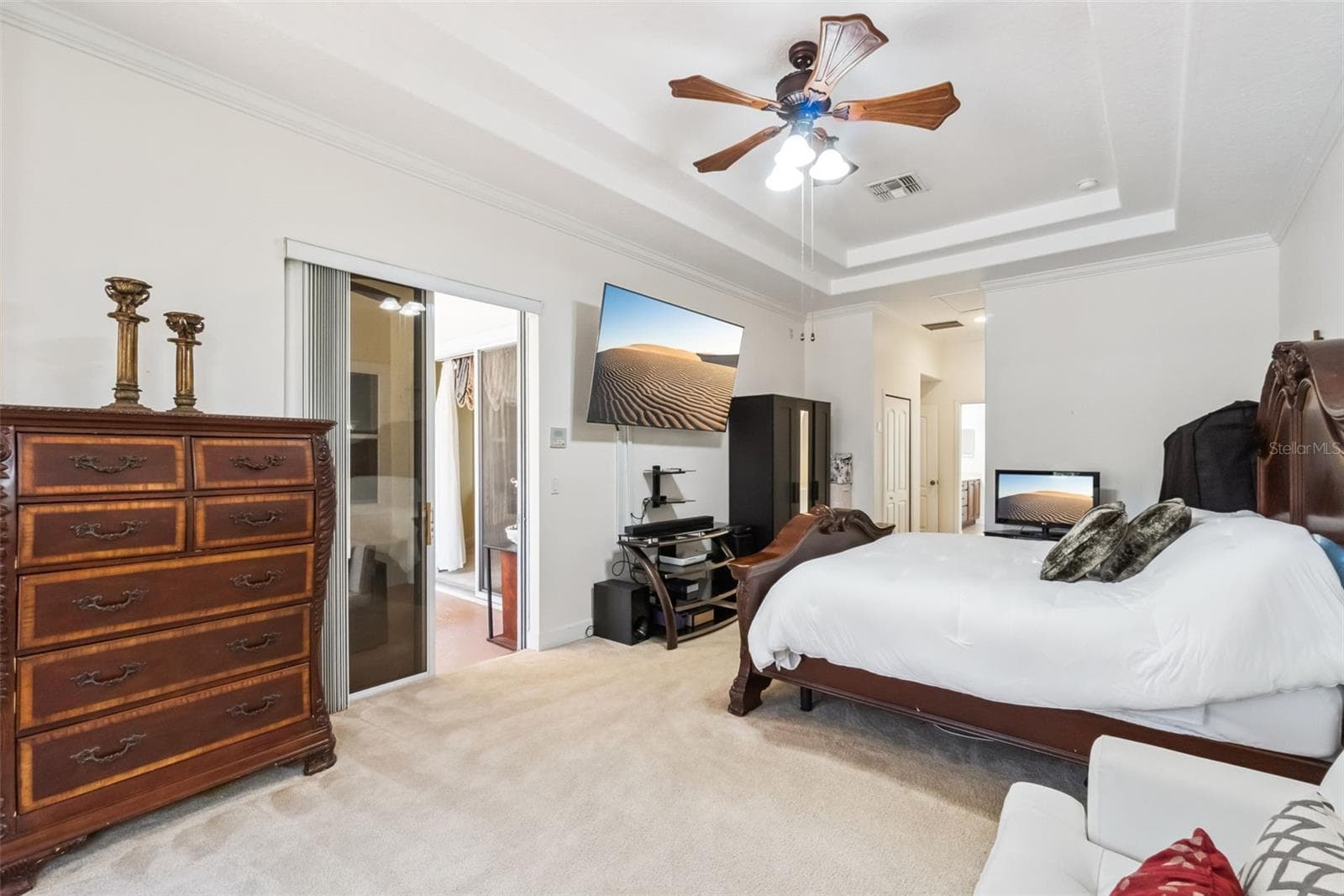 Primary suite with tray ceiling and barn door to the ensuite bathroom - 1112 CALLAWAY CIR, CLERMONT