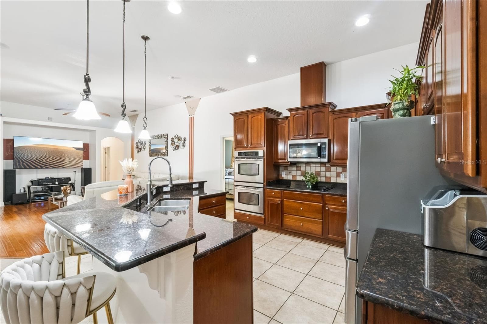 Kitchen island with granite counters and pendant lighting - 1112 CALLAWAY CIR, CLERMONT