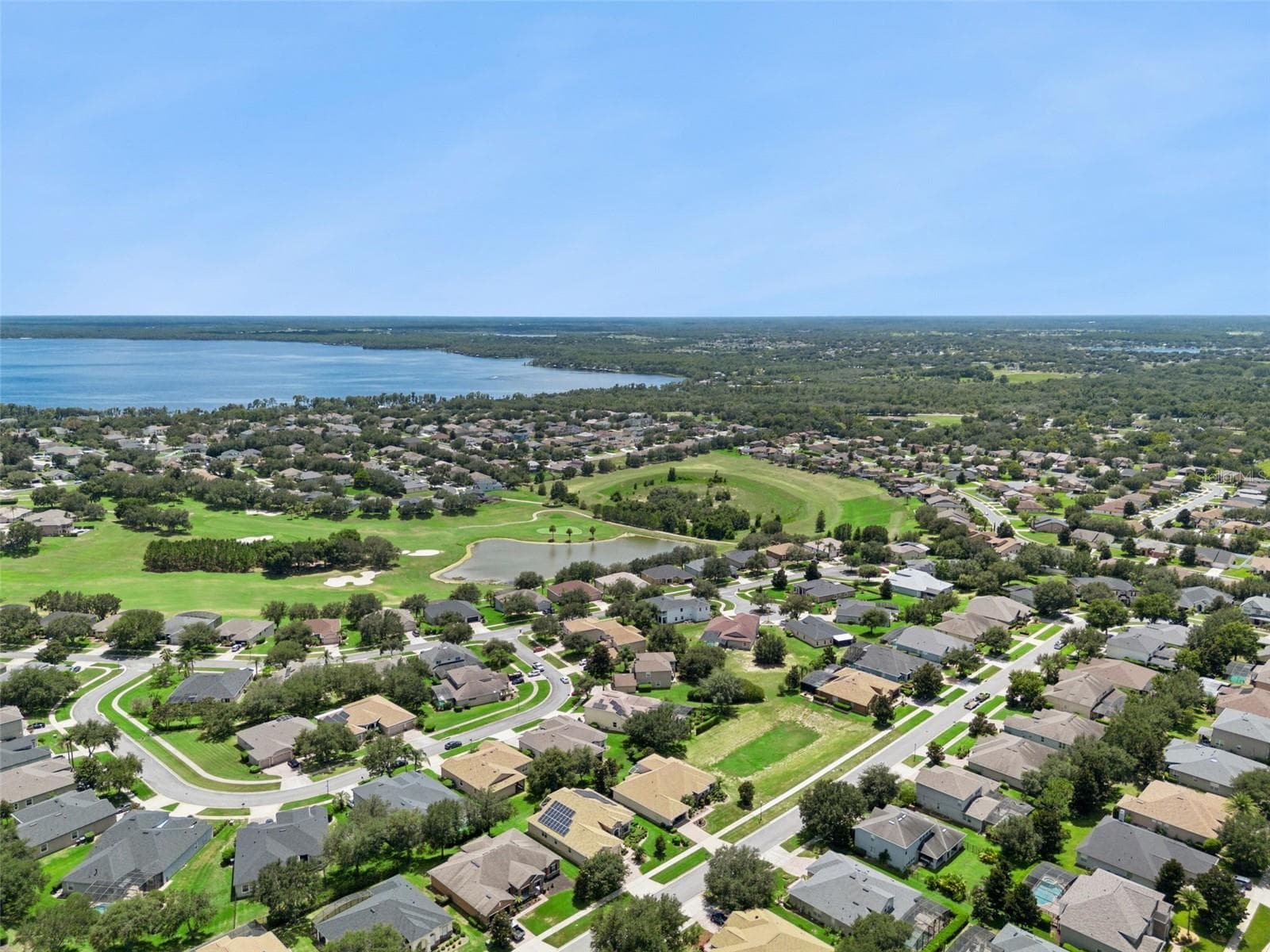 Aerial of the community with golf course and lake views - 1112 CALLAWAY CIR, CLERMONT