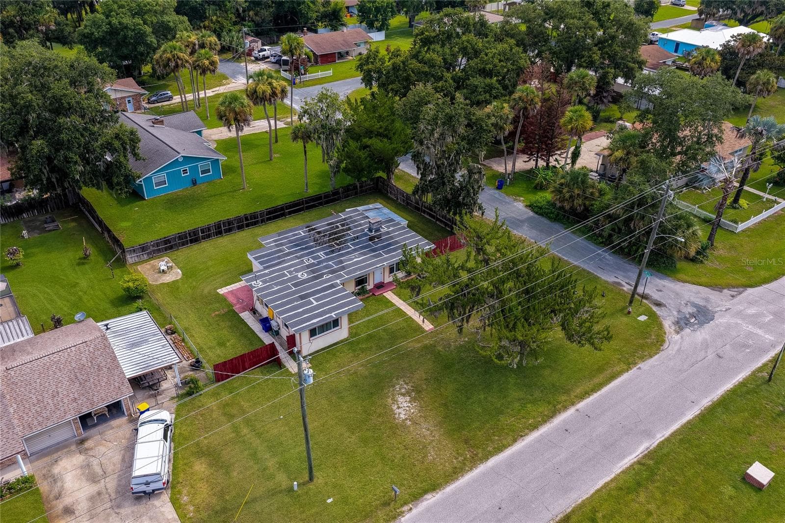 Elevated aerial view of the home and surrounding residential neighborhood showing a corner lot layout, and lush greenery. - 1101 16TH ST, EDGEWATER