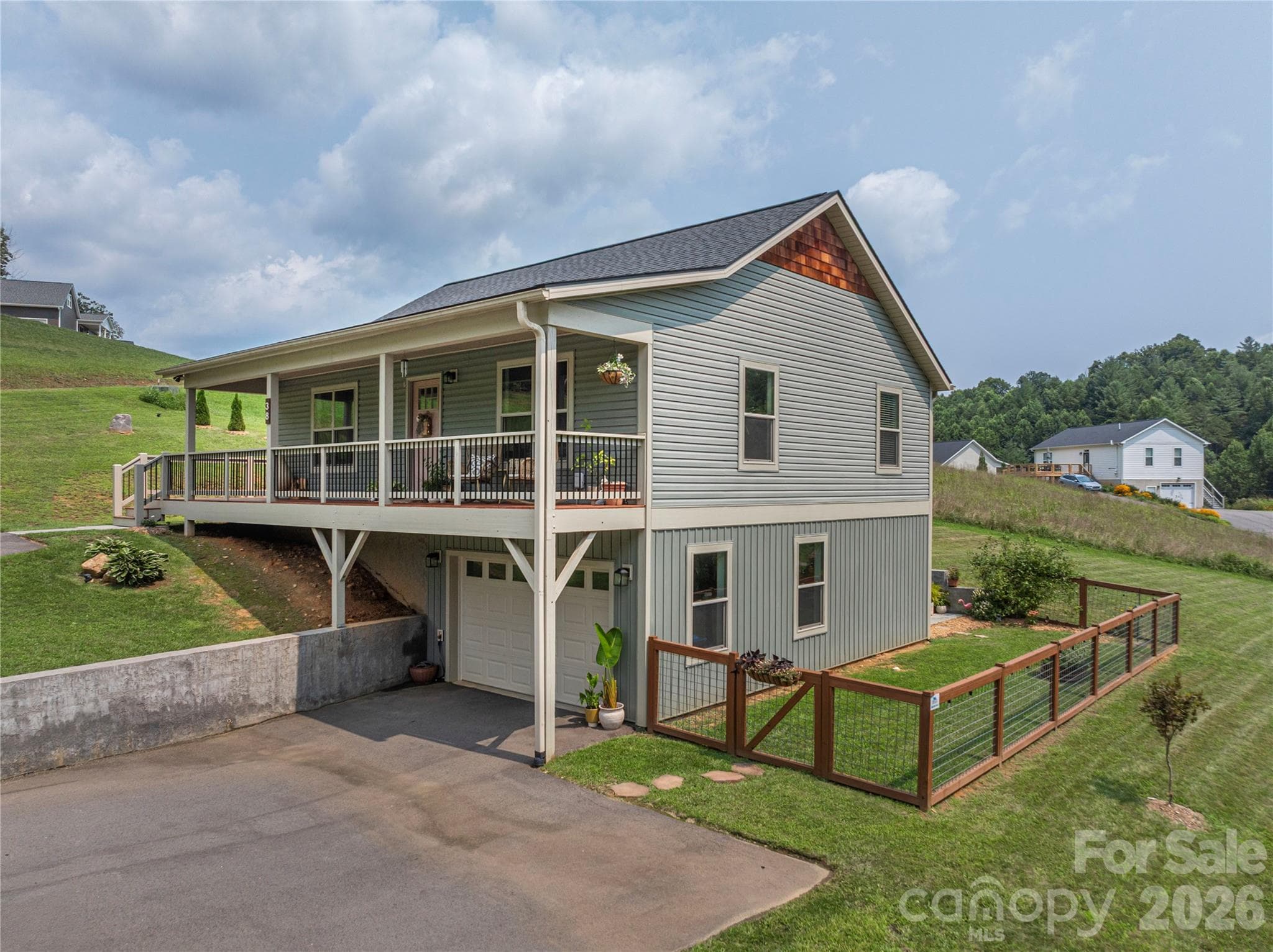 Large wraparound front porch, partially covered - 38 Sunrise Drive, Mars Hill