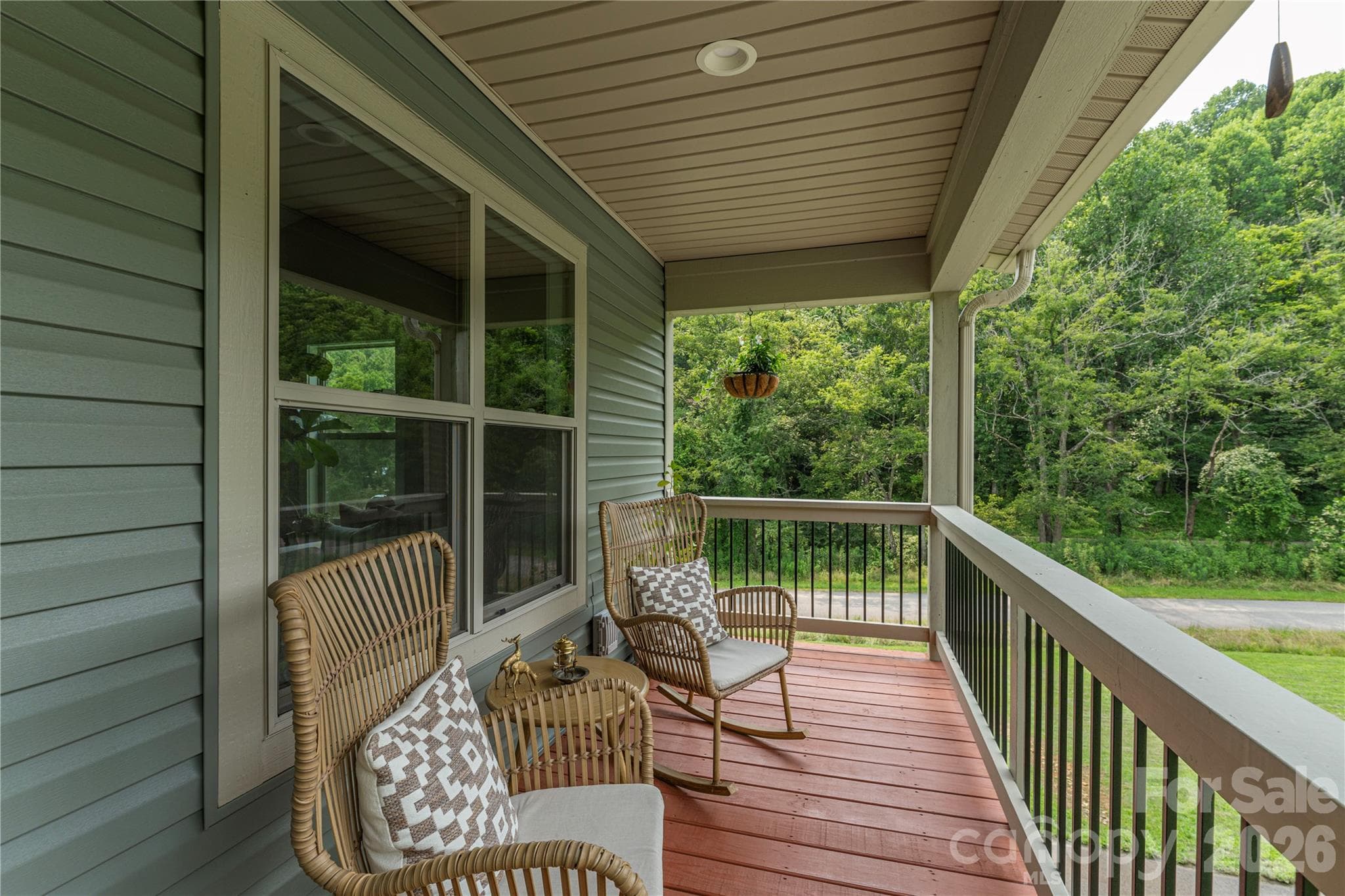 Inviting front porch is the perfect place for enjoying morning coffee, listening to the rain, or simply taking in the pastoral view of grazing horses nearby. - 38 Sunrise Drive, Mars Hill