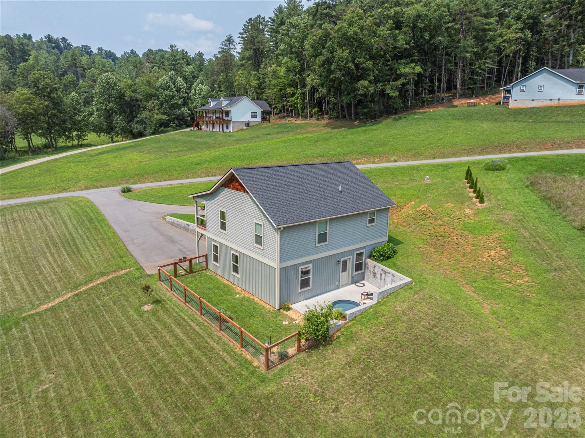 The spacious grounds provide plenty of sun and room for gardening, enjoying nature, and outdoor recreation, all with added privacy. - 38 Sunrise Drive, Mars Hill