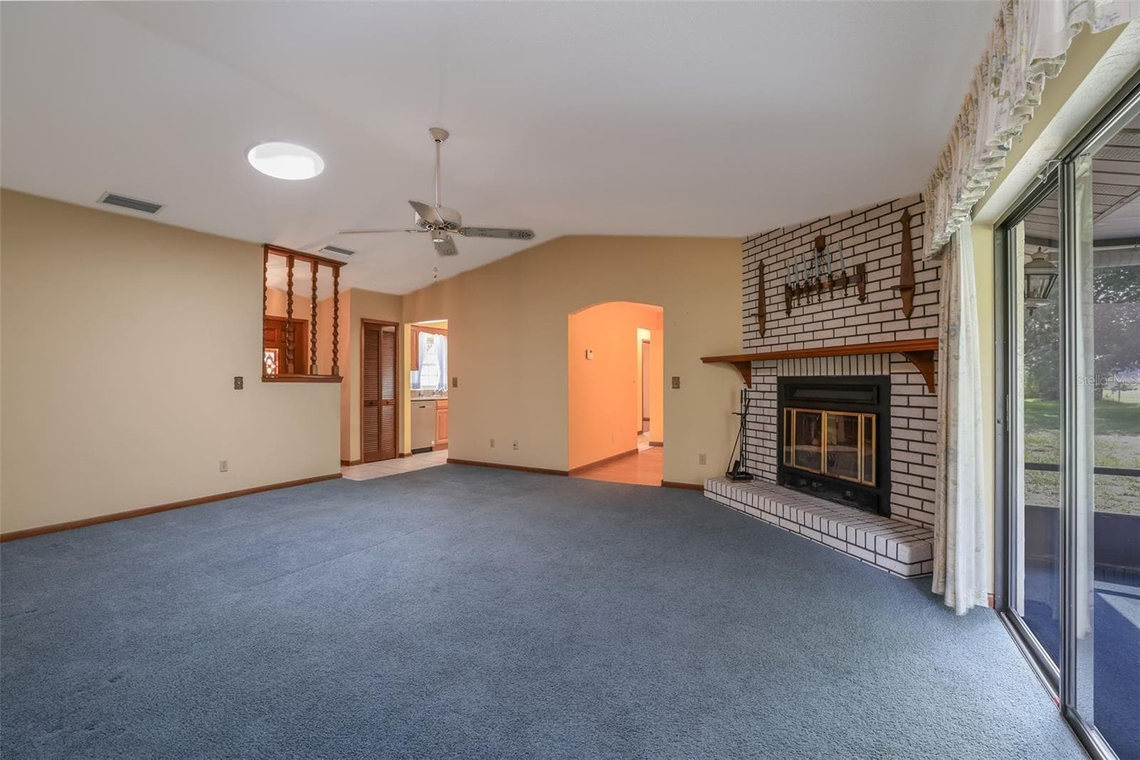 Living Room with Wood-burning Fireplace - 229 GEORGETOWNE BLVD, DAYTONA BEACH