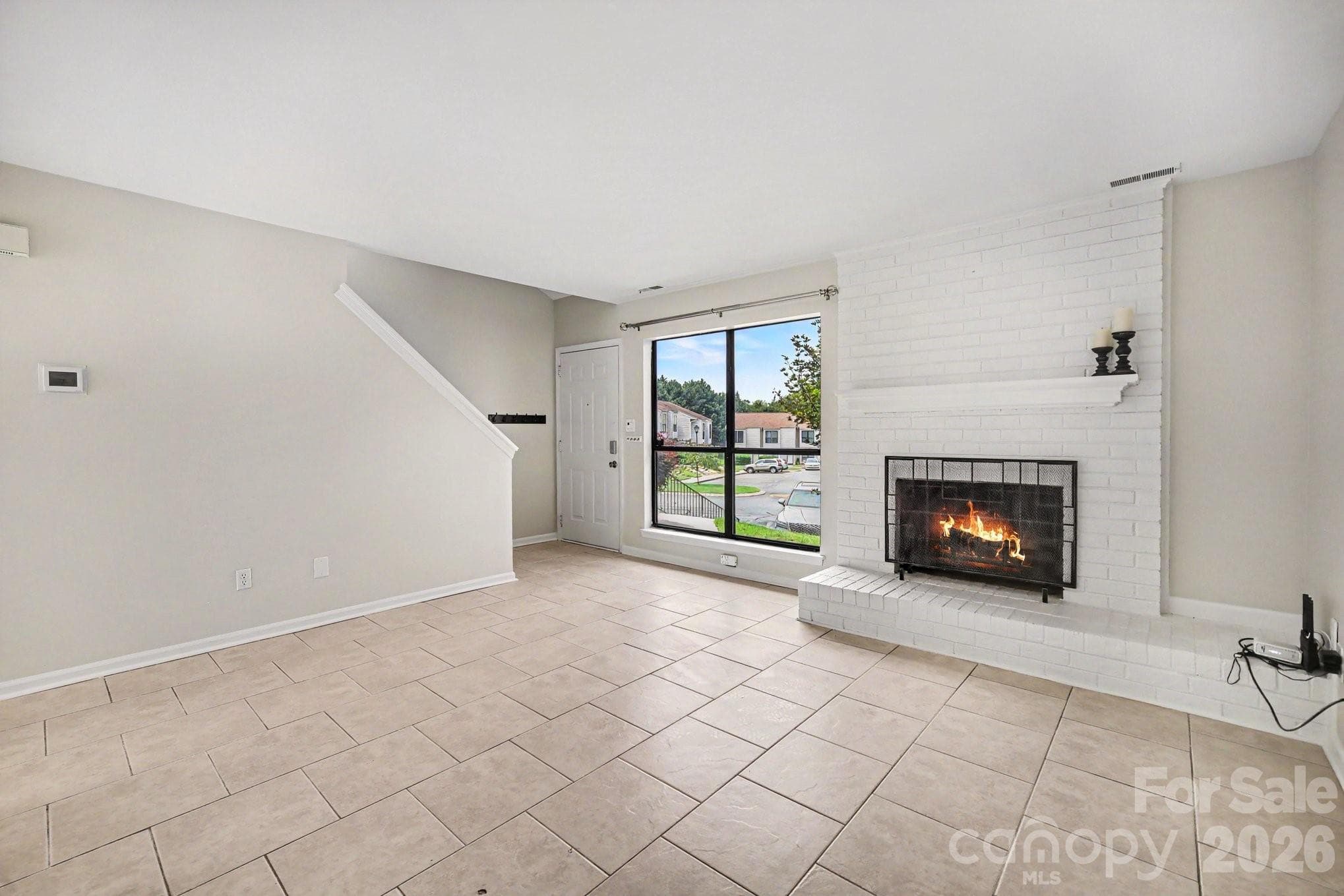 Living room w/ wood burning fireplace, easy care tile floor, neutral paint throughout - 11009 Carmel Crossing Road, Charlotte