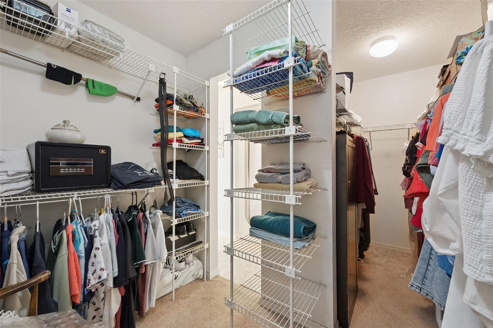 Primary walk-in closet with built-in wire shelving system at this split-plan Mount Dora home priced at $199/sq ft - 480 LAKE FOREST CIR, MOUNT DORA