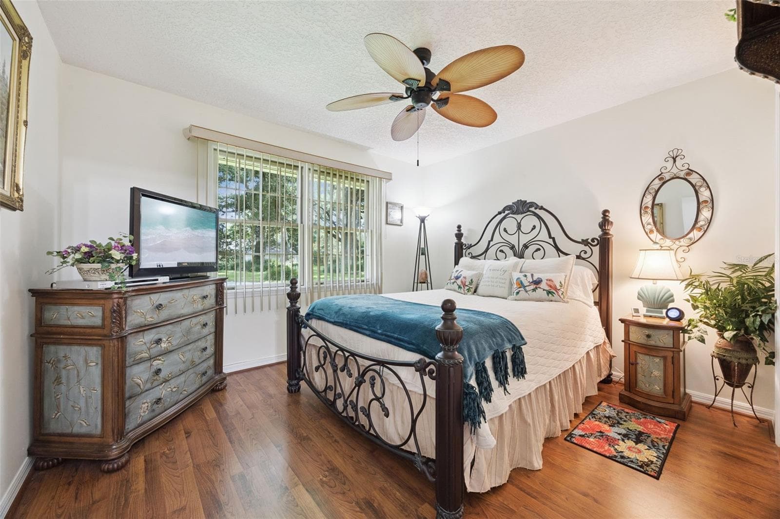 Bedroom 2 (12x11) with ceiling fan, built-in closet, and laminate floors, ideal as a guest room or home office at 480 Lake Forest Cir - 480 LAKE FOREST CIR, MOUNT DORA