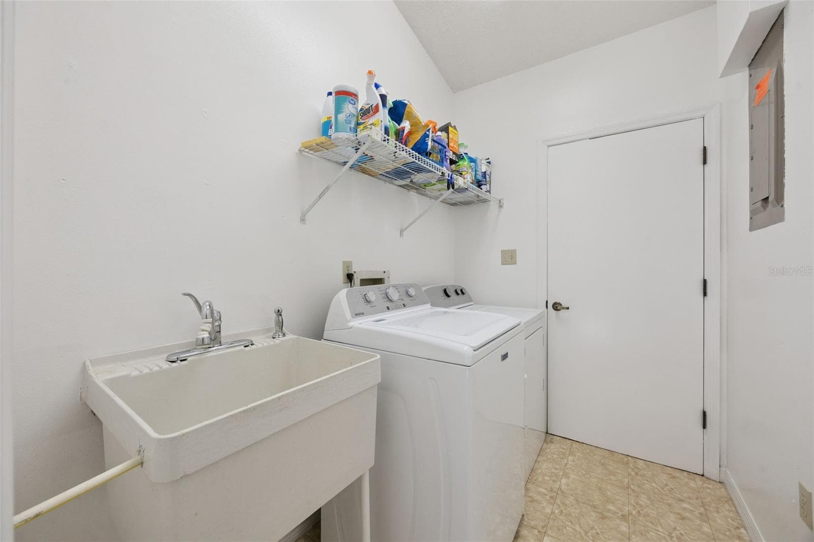 Laundry room with utility sink and washer/dryer included at 480 Lake Forest Cir, all major appliances convey with this Mount Dora home - 480 LAKE FOREST CIR, MOUNT DORA