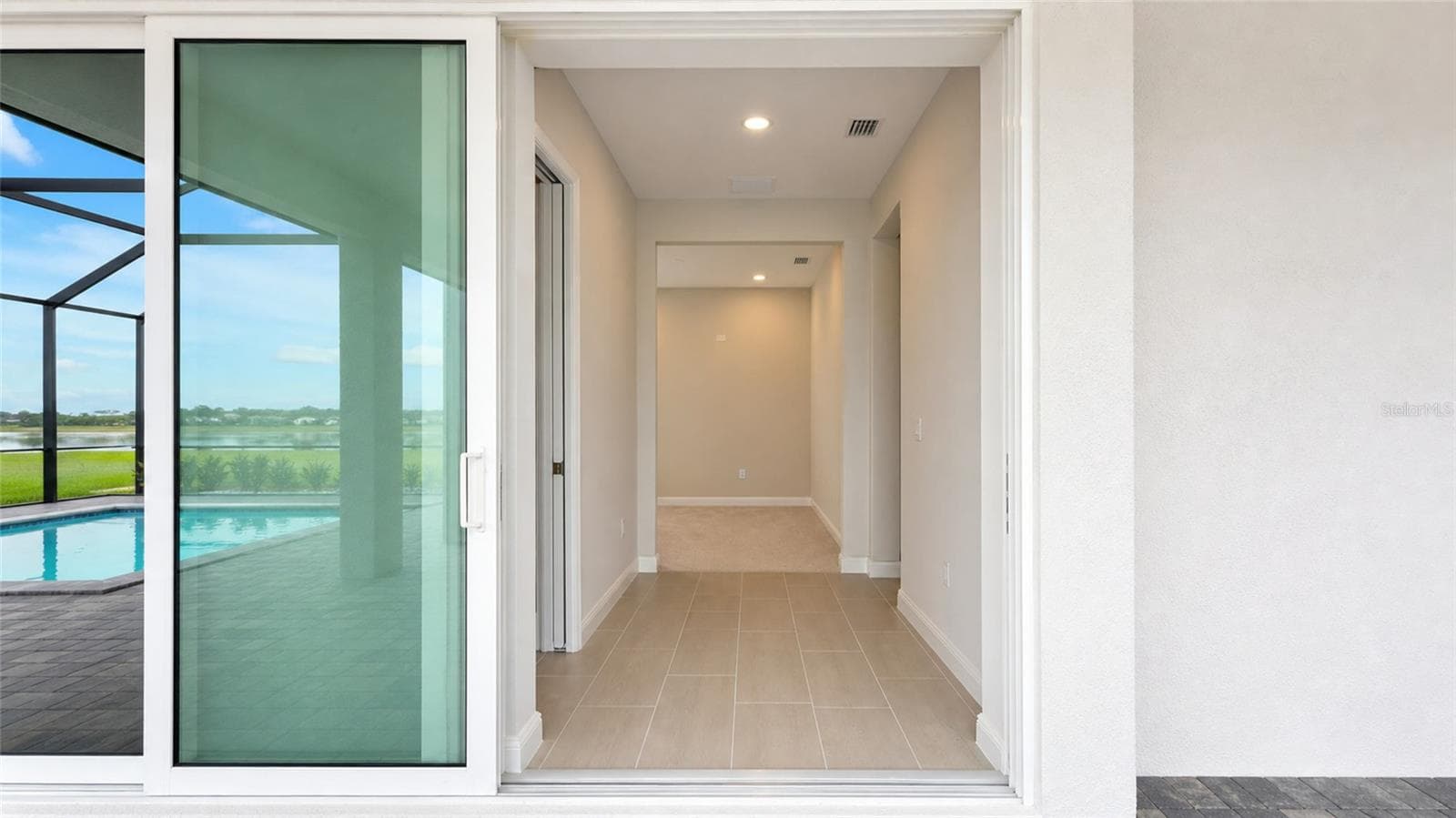 Disappearing Pocket Sliding Glass Door from rear hallway to lanai - 812 BLUE SHELL LOOP, SARASOTA