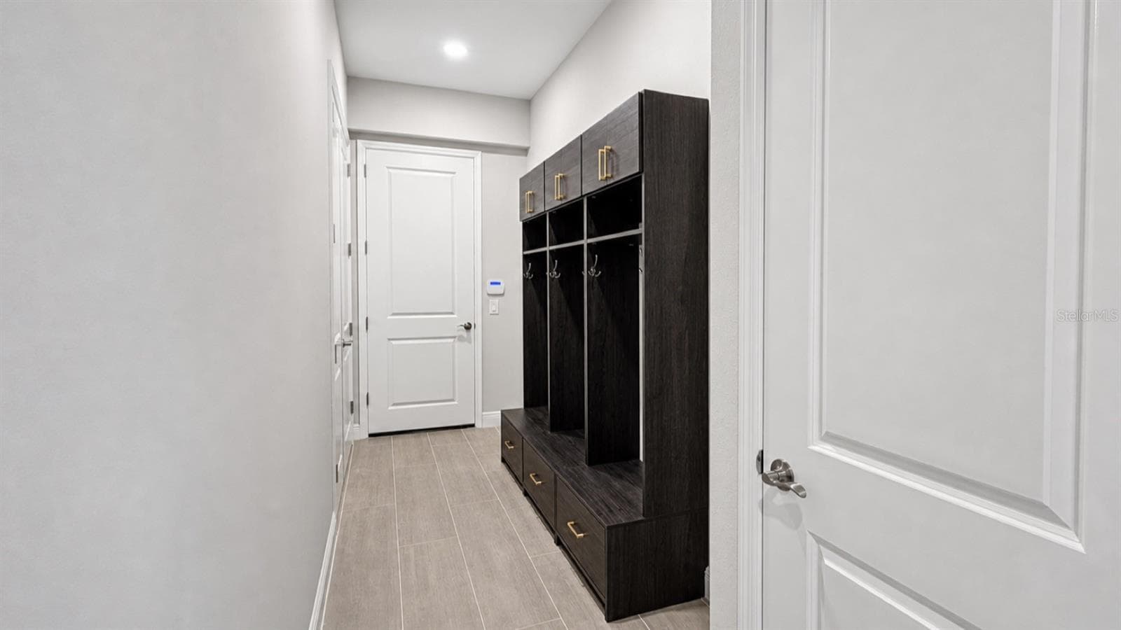 Mud Room Features Built In Benches and Cabinet Storage - 812 BLUE SHELL LOOP, SARASOTA