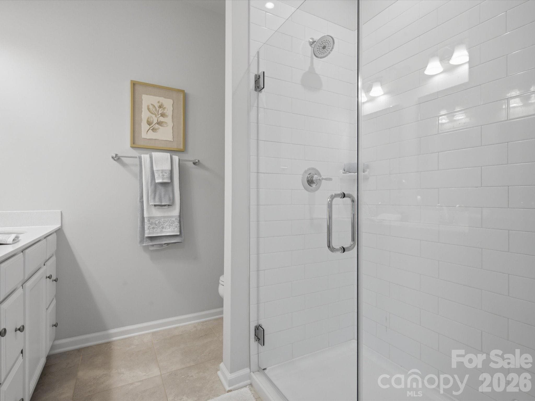 Primary bathroom with frameless shower door. - 4014 Edenborn Lane, Charlotte