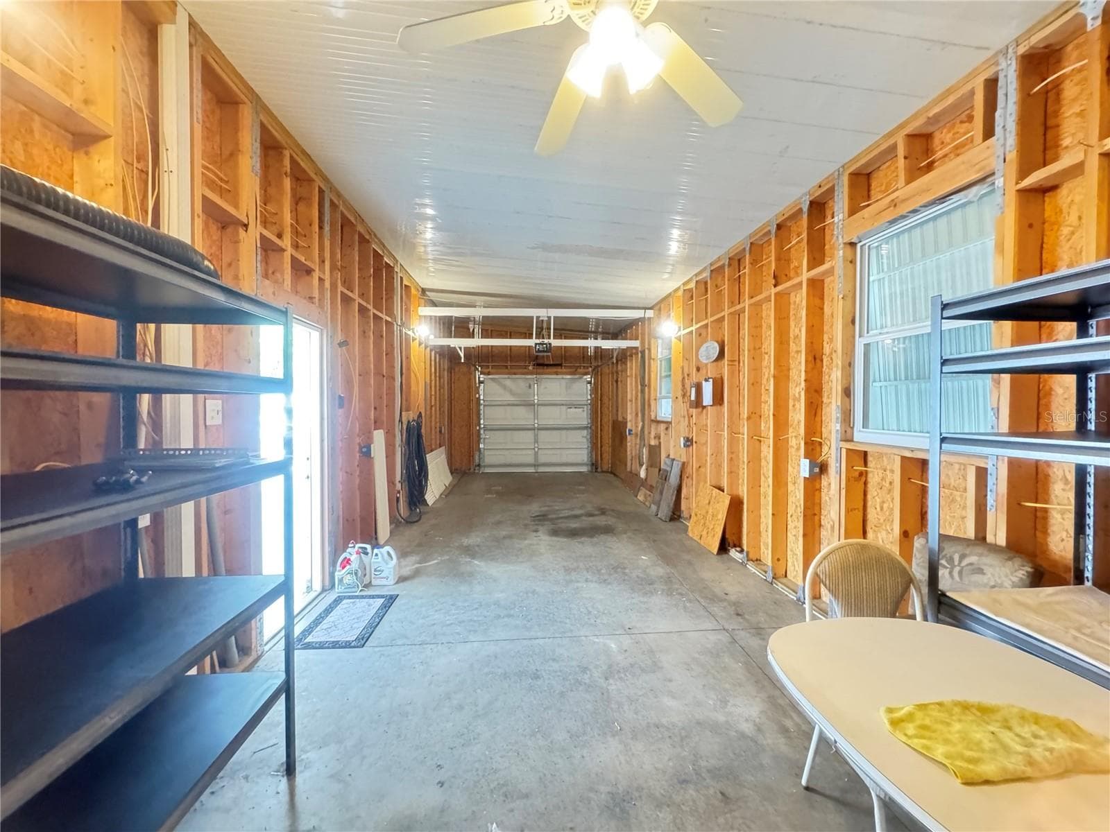 Garage Interior looking towards garage door - 35103 JADE DR, ZEPHYRHILLS