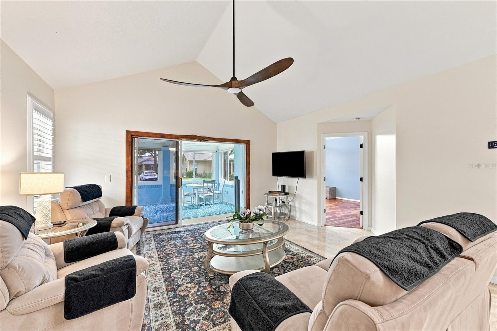 Walk in to a spacious and beautiful living room with plantation shutters, custom ceiling fans and high ceilings! - 1124 GOLFVIEW WOODS DR #na, SUN CITY CENTER