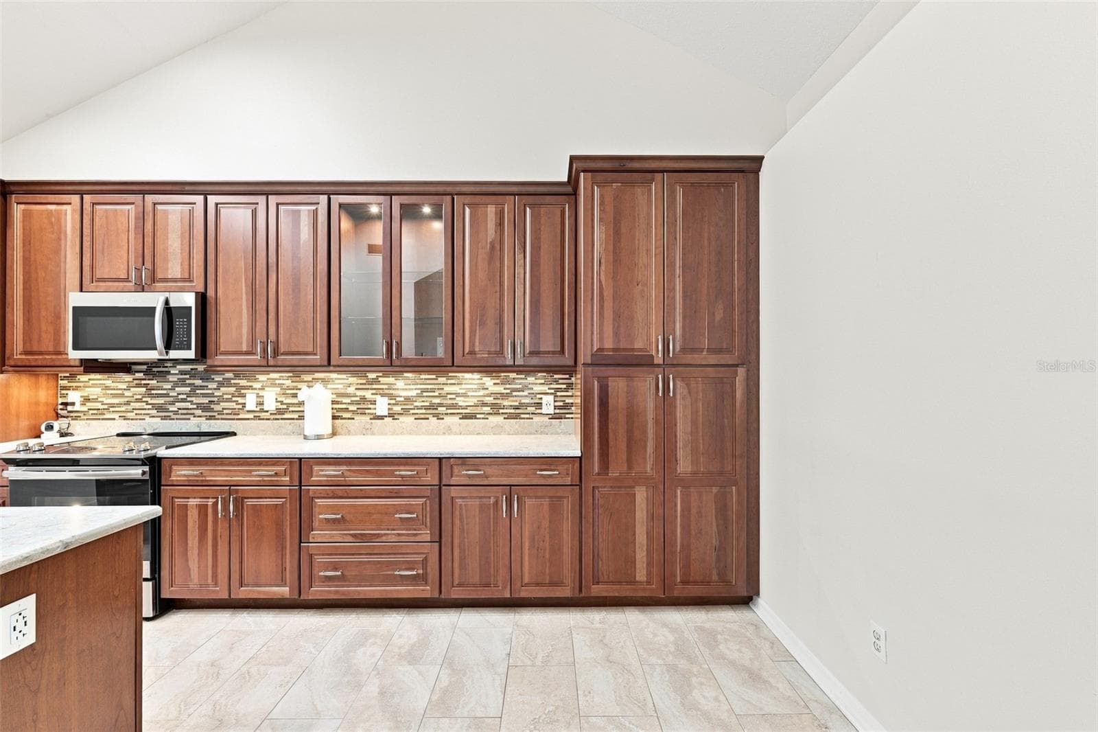 Lovely under cabinet lighting, modern tile backsplash and wall wood cabinetry. - 1124 GOLFVIEW WOODS DR #na, SUN CITY CENTER