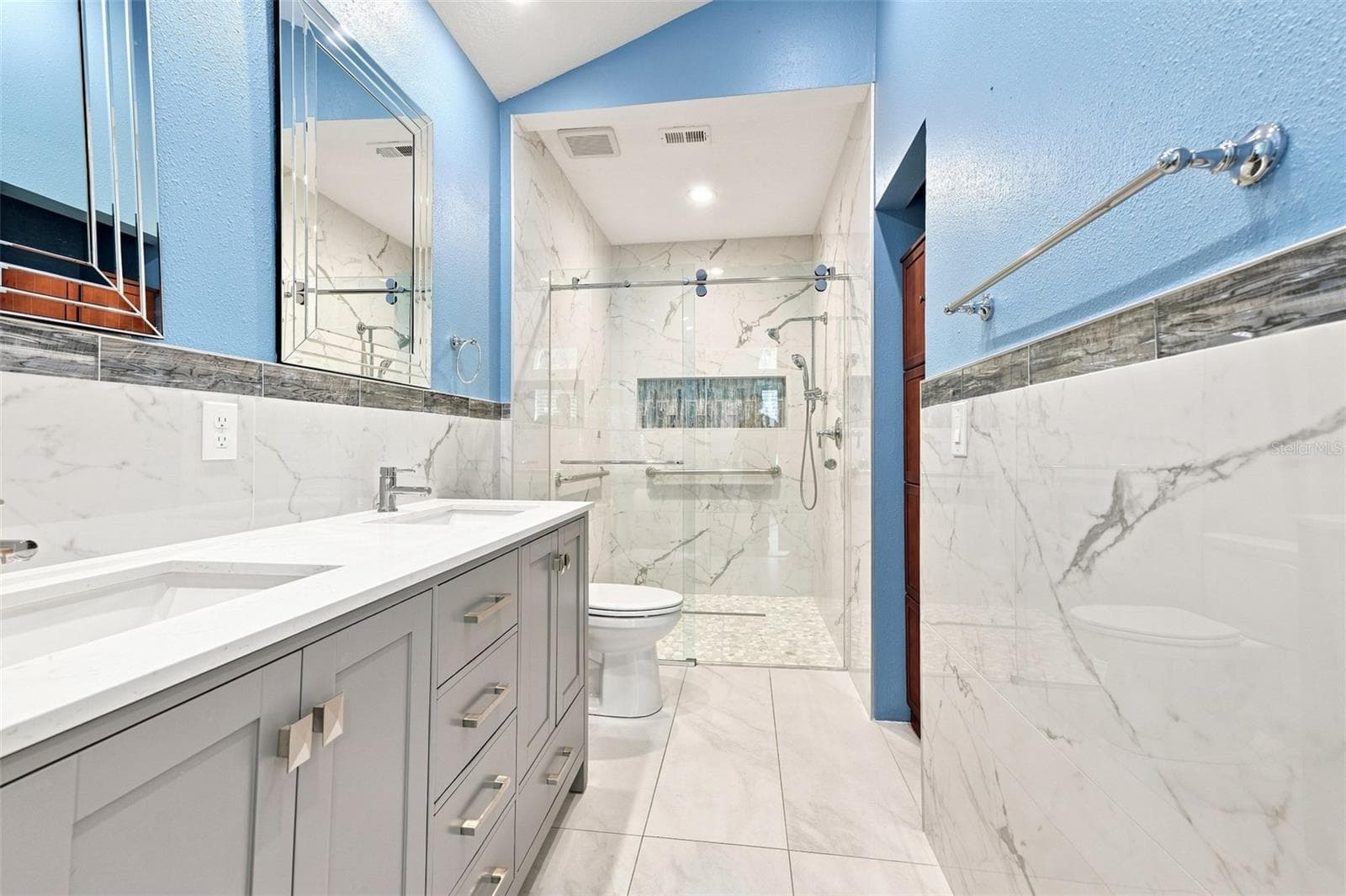 Ensuite bathroom has double sinks, lots of storage capacity and a visually stunning shower. - 1124 GOLFVIEW WOODS DR #na, SUN CITY CENTER