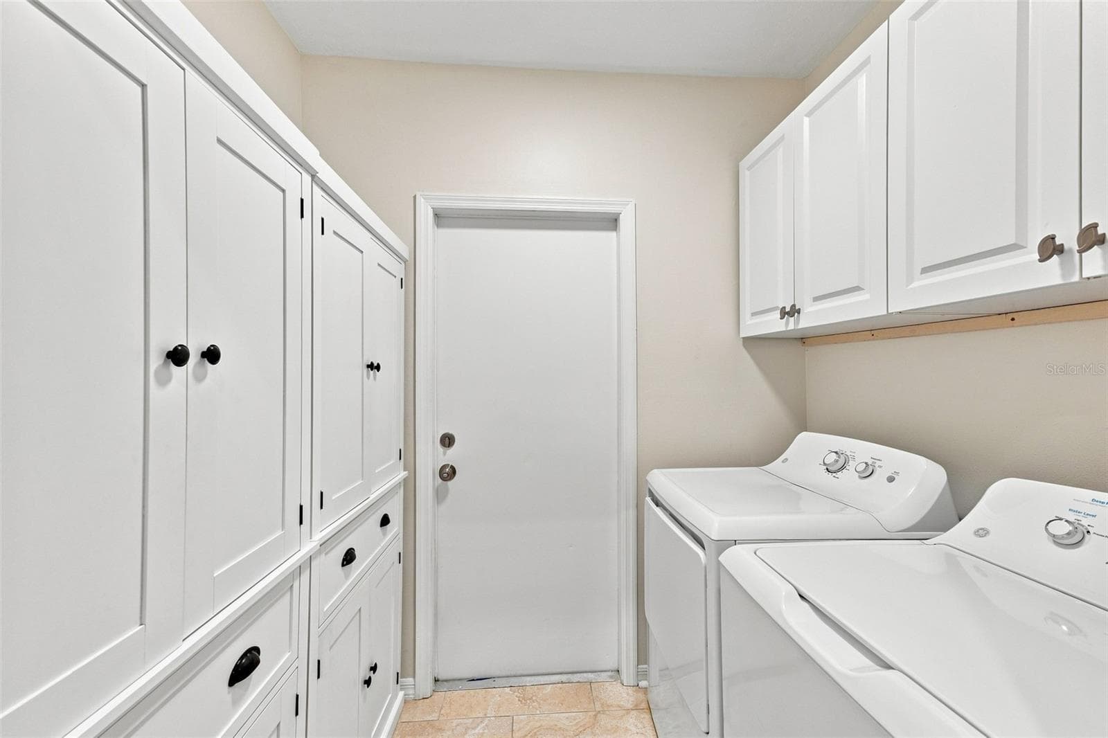 Inside laundry room is wonderfully appointed with storage capacity allowing room for everything. - 1124 GOLFVIEW WOODS DR #na, SUN CITY CENTER