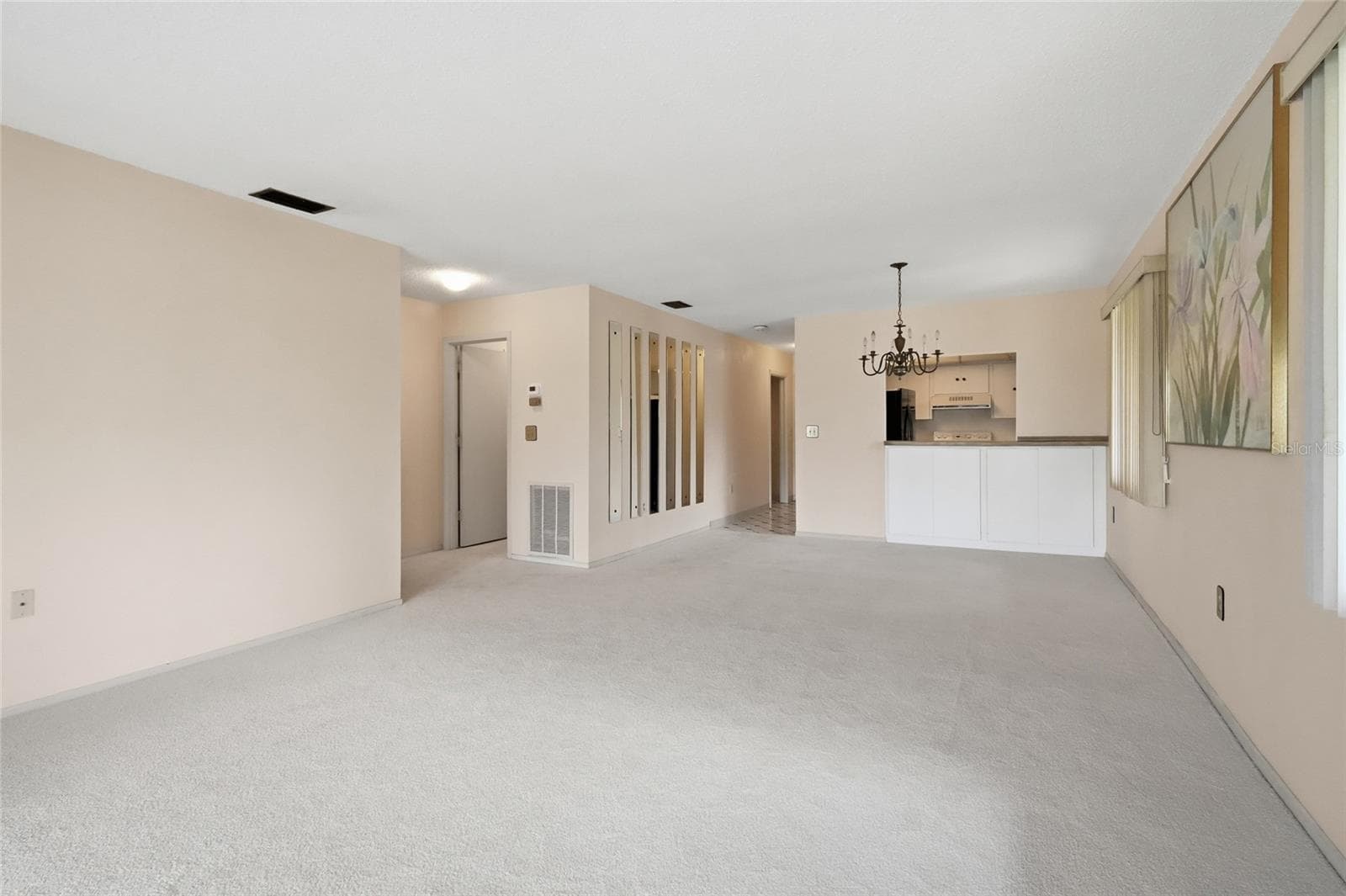 dining room/living room view of kitchen and entry way - 3500 EL CONQUISTADOR PKWY #332, BRADENTON