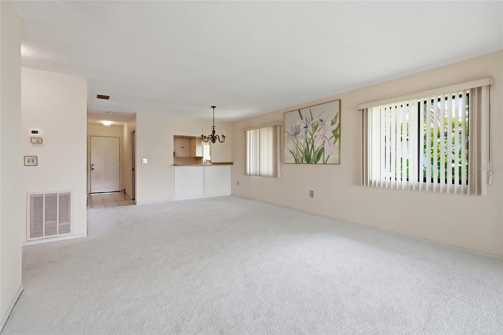 dining room/living room view of entry way and kitchen - 3500 EL CONQUISTADOR PKWY #332, BRADENTON