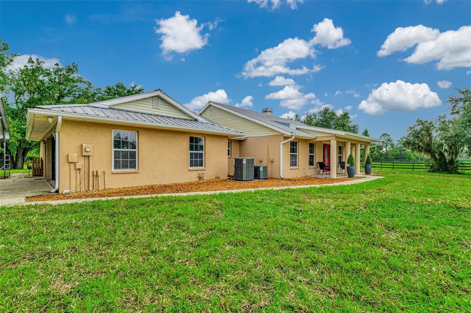 2 car attached garage with a covered carport for extra parking space - 4610 403RD ST E, MYAKKA CITY