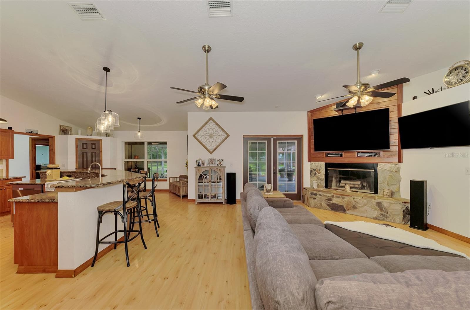 French doors lead to the super-sized screened lanai - 4610 403RD ST E, MYAKKA CITY