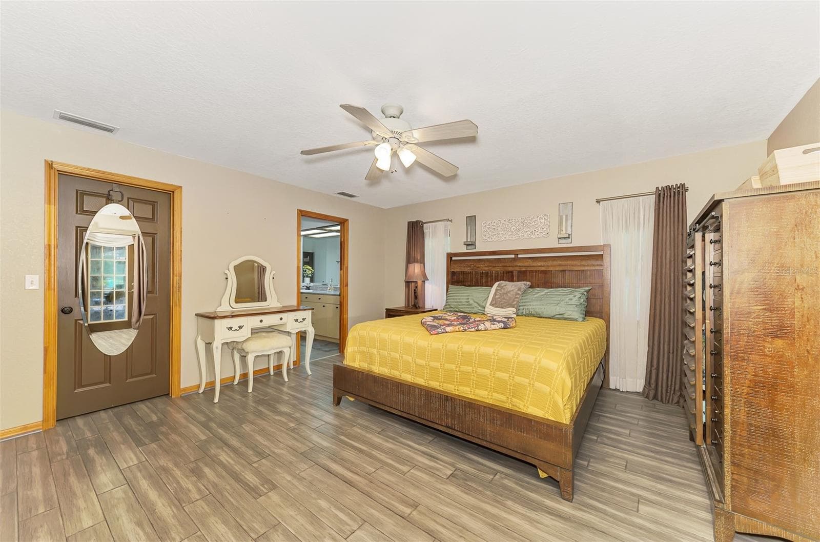 Primary bedroom with a huge walk in closet and private spa like bathroom - 4610 403RD ST E, MYAKKA CITY