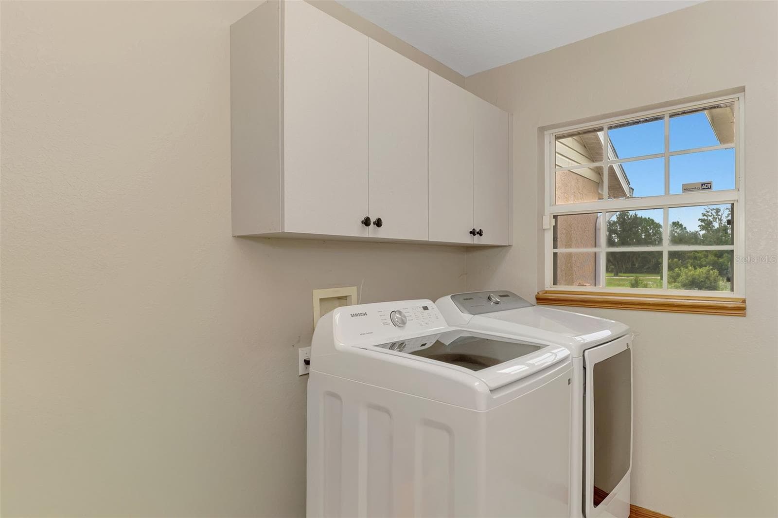 Laundry room with sink is right off the garage area and also has the whole house vacuum equipment - 4610 403RD ST E, MYAKKA CITY