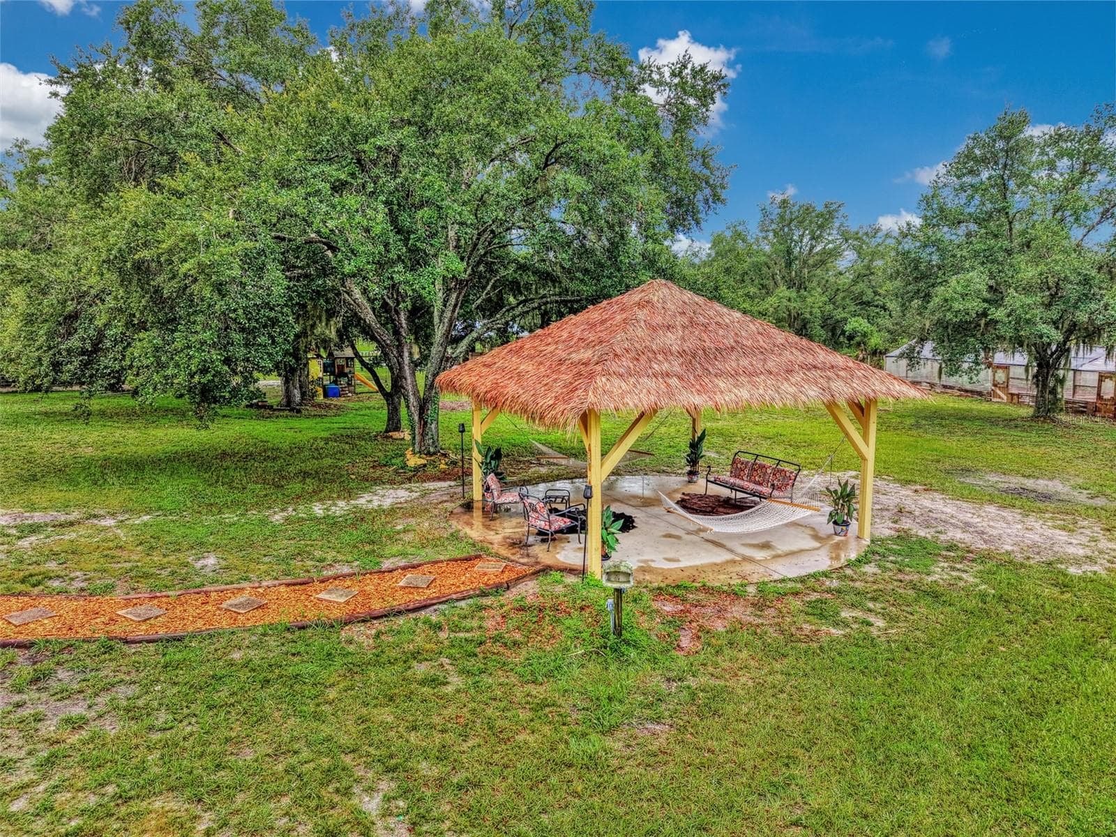 Tiki hut provides a super spot to grill and relax in a hammock - 4610 403RD ST E, MYAKKA CITY
