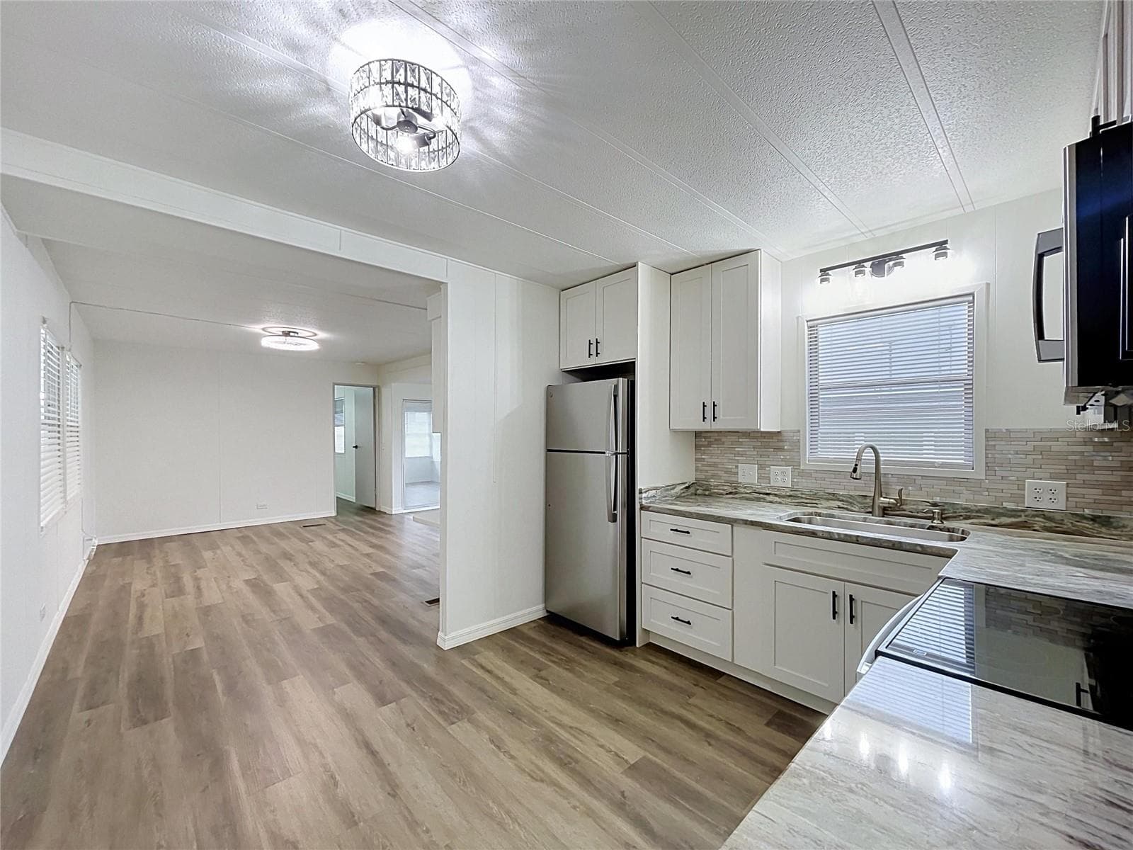 Open Kitchen with Luxury Vinyl Plank Flooring thru-out - 6965 FORT KING RD, ZEPHYRHILLS