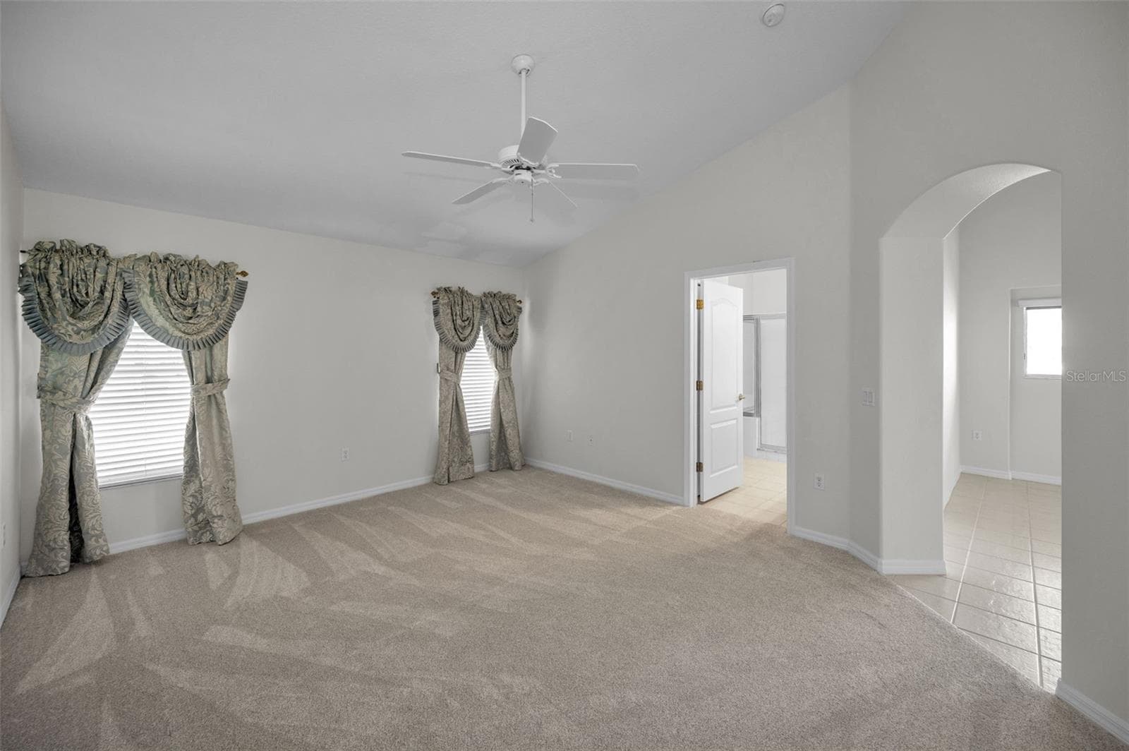 ANOTHER VIEW OF THE PRIMARY BEDROOM WITH ENTRANCE TO THE ENSUITE BATHROOM. - 12021 FERN TERRACE CT, TRINITY