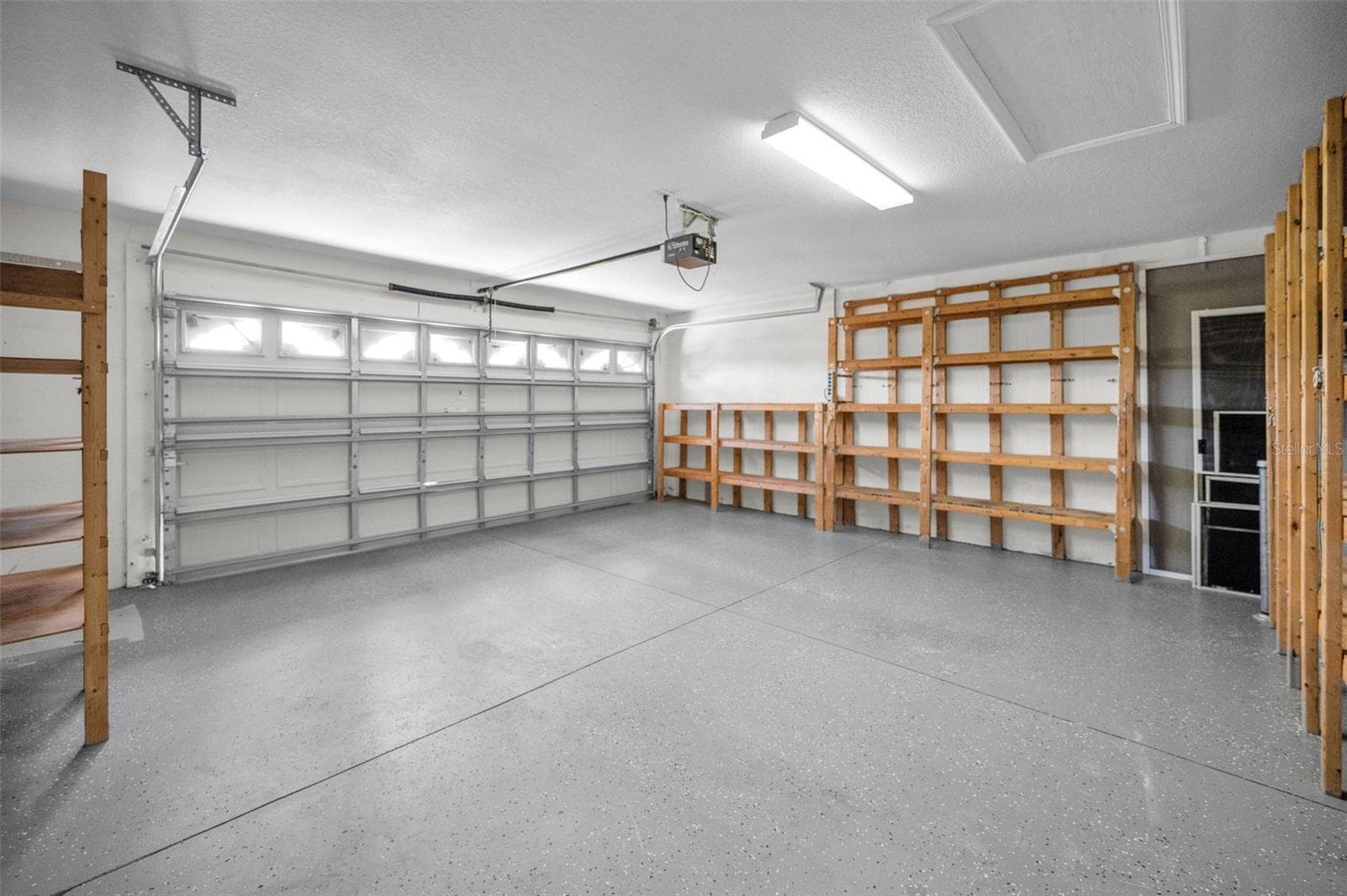 LARGE TWO CAR GARAGE WITH PLENTY OF ROOM FOR STORAGE. - 12021 FERN TERRACE CT, TRINITY