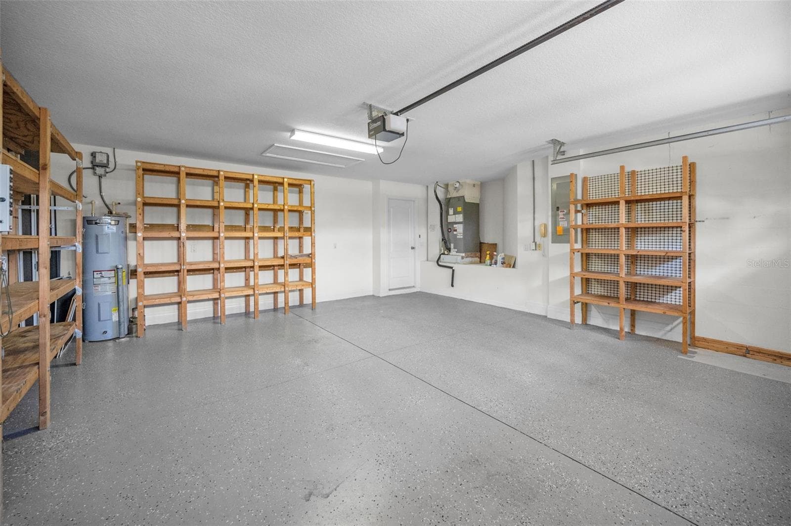 VIEW OF 2 CAR GARAGE AND DOOR TO LAUNDREY ROOM. - 12021 FERN TERRACE CT, TRINITY